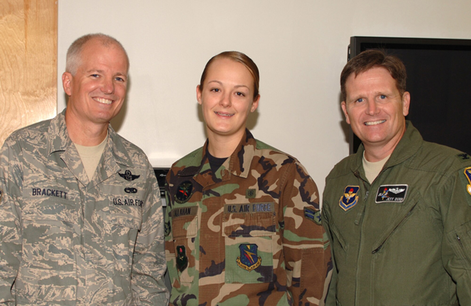 Airman 1st Class Jennifer Callahan, 14th Medical Operations Squadron, is notified of her selection for senior airman below the zone. Colonel Jeff Dunn, 14th Flying Wing Training vice commander, and Chief Master Sgt. Richard Brackett, 14th Flying Training Wing Command Chief Master Sergeant, shared the news with her Oct. 2. (U.S. Air Force photo by Elizabeth Owens)