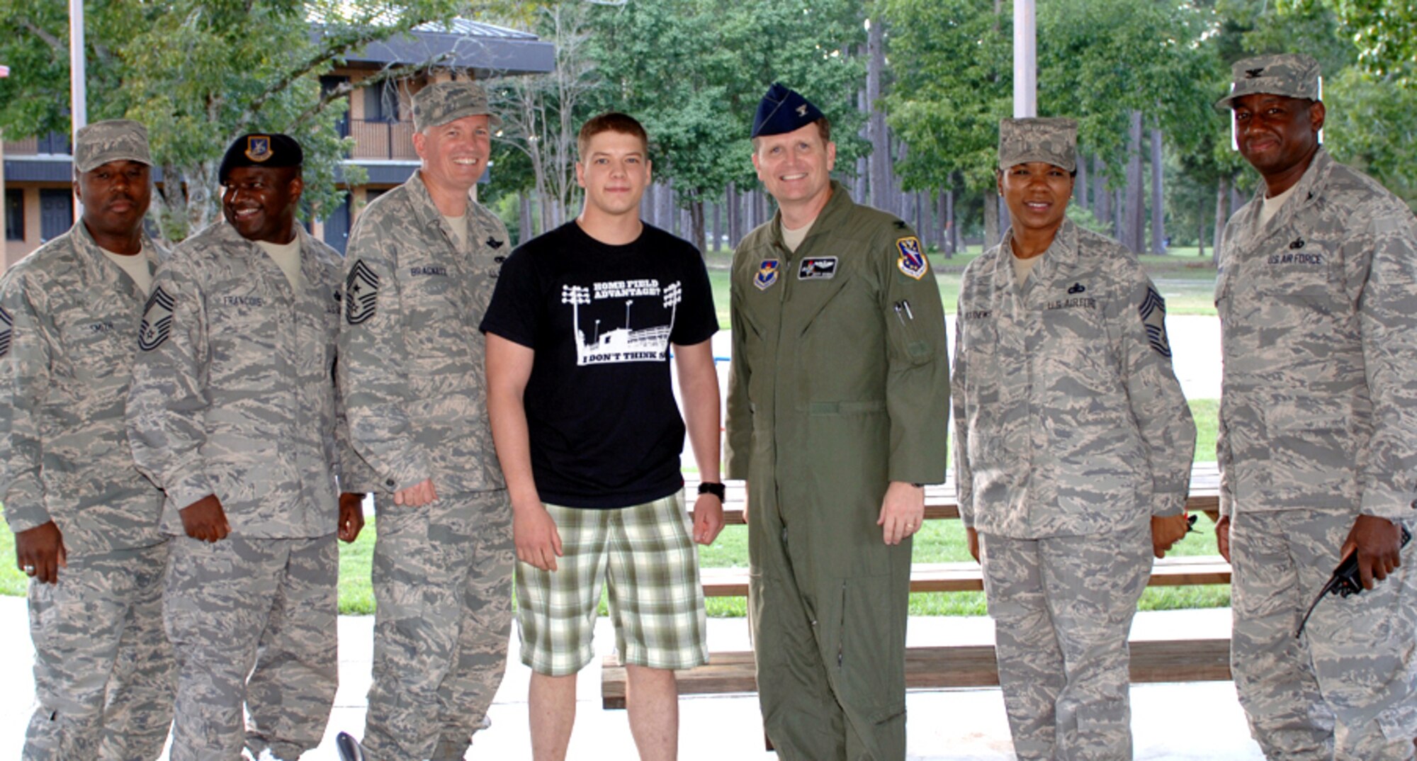 A surprised Airman 1st Class Mark Bolding, 14th Security Forces Squadron, finds out he has been selected to be promoted to senior airman below the zone. The news was given to him by Senior Master Sgt. Zefrem Smith, 14th Operations Group superintendent, Chief Master Sgt. Bertell Francois, 14th Security Forces superintendent, Chief Master Sgt. Richard Brackett, 14th Flying Training Wing Command Chief Master Sergeant, Col. Jeff Dunn, 14th Flying Training Wing vice commander, Chief Master Sgt. Pamela Matthews, 14th Medical Support Group superintendent, and Col. Mark Brown, 14th Mission Support Group commander. (U.S. Air Force photo by Elizabeth Owens)