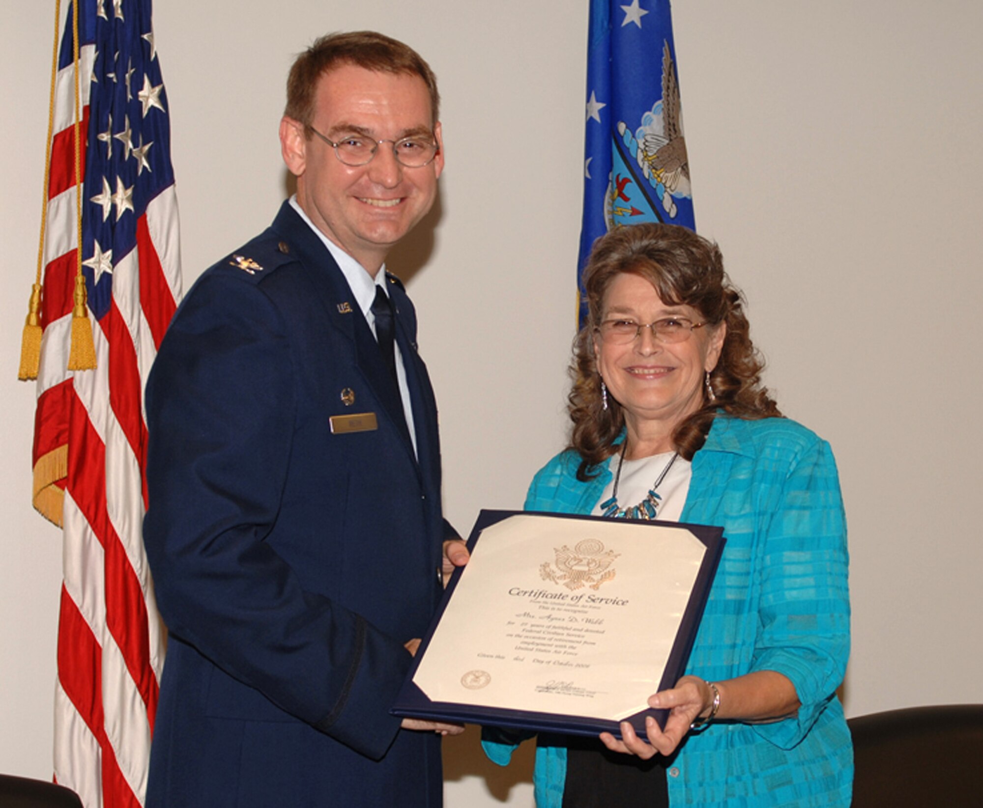 Agnes Webb, 14th Operations Group Budget Analyst, accepts her Certificate of Service from Col. David Reth, 14th Operations Group commander. Mrs. Webb retired Oct. 1 after 27 years of service to Columbus AFB. (U.S. Air Force photo by Elizabeth Owens)