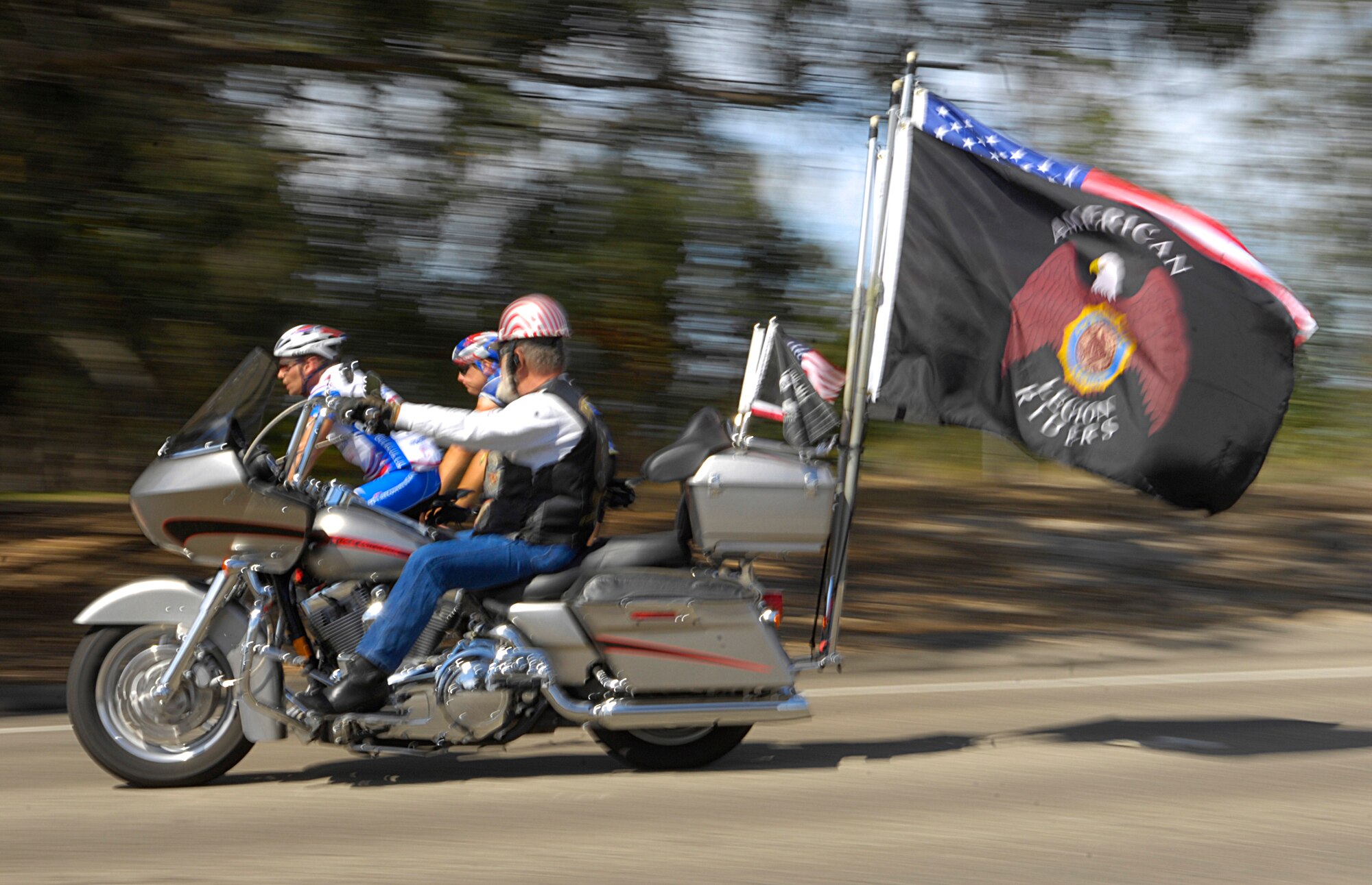 VANDENBERG AIR FORCE BASE, Calif. --  Jim Banakus, a U.S. Navy veteran, rides his motorcycle alongside a couple of 'Road 2 Recovery' bicyclists near Vandenberg during their trek from San Francisco to Los Angeles. The goal of the group is to assist with physical and mental rehabilitation programs for veterans.(U.S. Air Force Photo/ Airman 1st Class Andrew Lee)