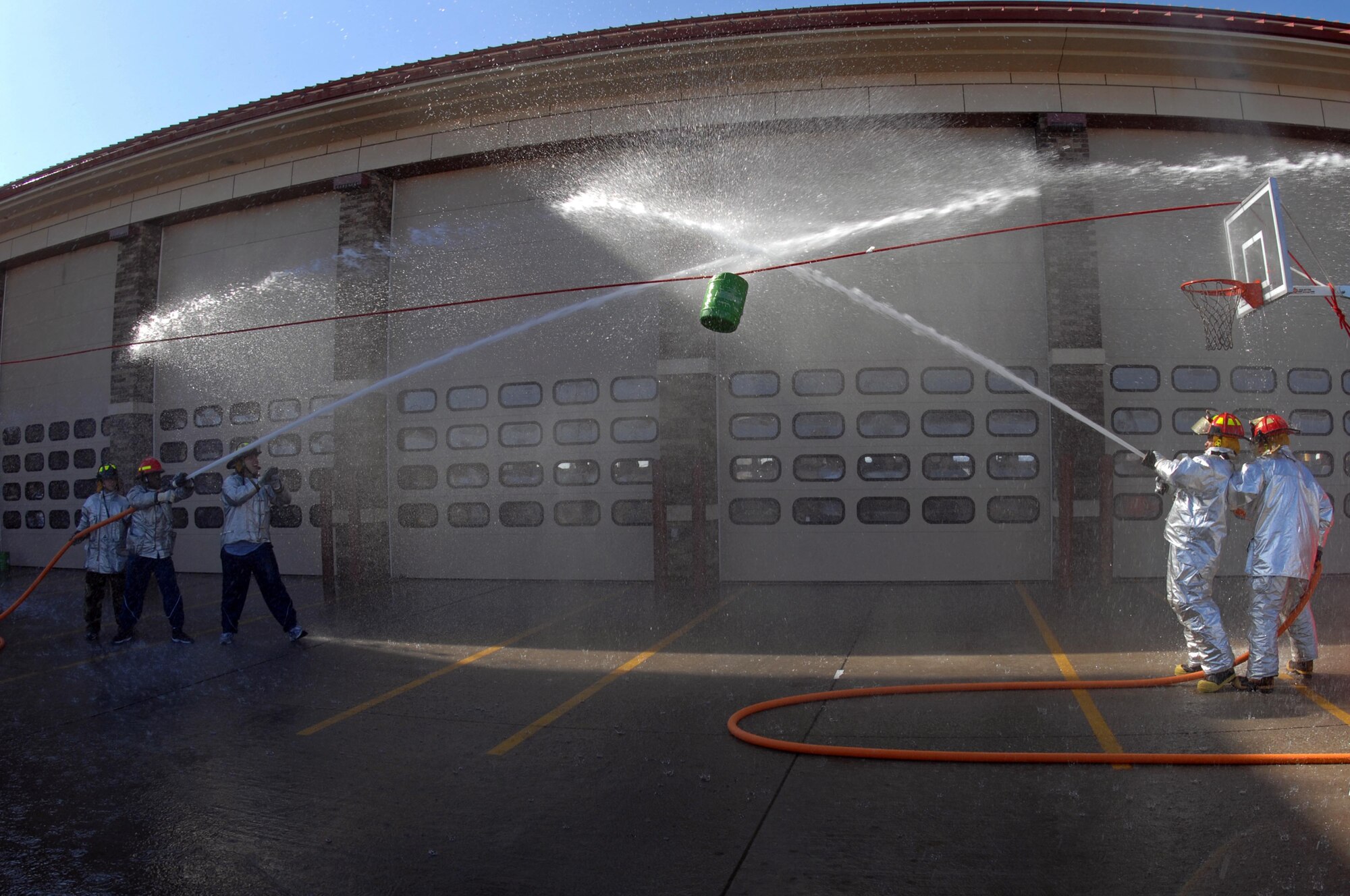 Members of the 28th Civil Engineer Squadron compete during a water barrel-spraying contest as part of the Firefighter Challenge Oct. 8. The electricians team took first place out of the eight 28 CES teams participating in the contest. (U.S. Air Force photo by Airman Corey Hook)