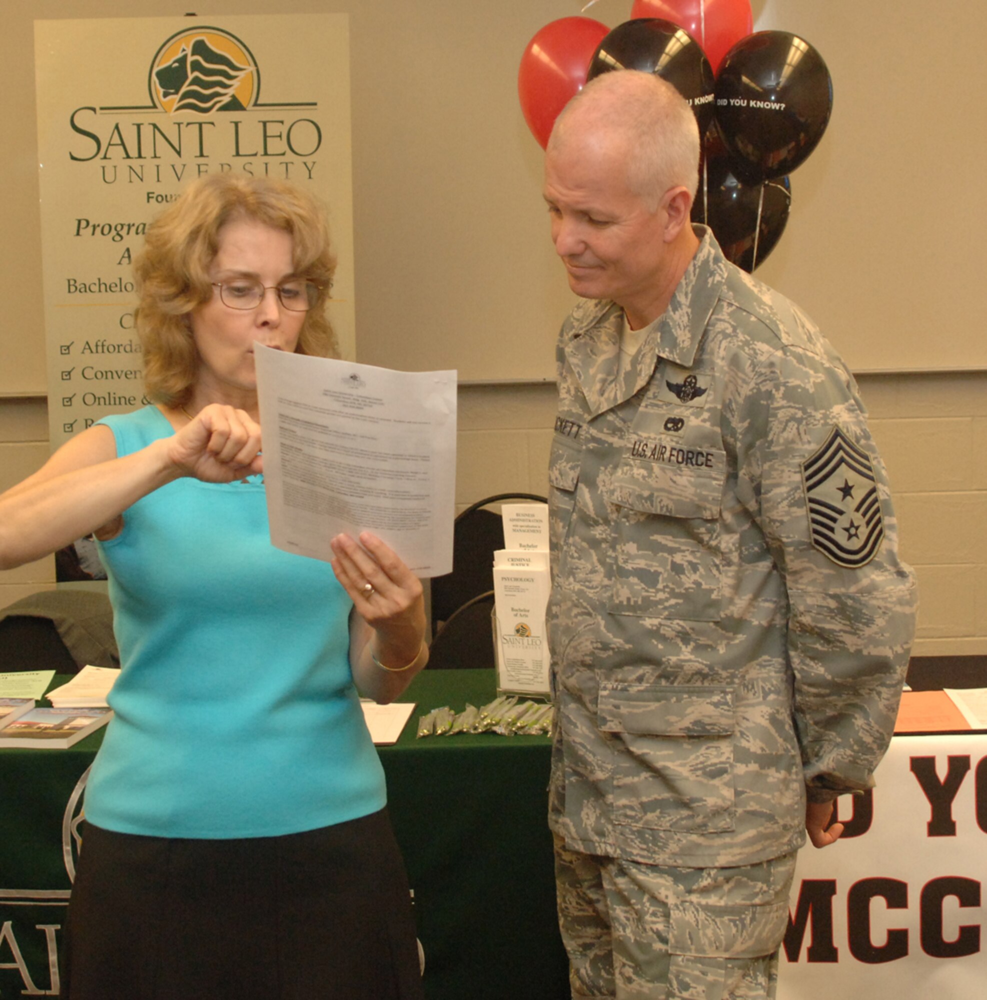 Dew White, director of St. Leo University at Columbus AFB, explains to Chief Master Sgt. Richard Brackett, Columbus AFB Command Chief, the options that are available to BLAZE team members and their families through the education center on base at the St. Leo University open house. Airmen and their dependents can receive degrees in Business Administration, Criminal Justice and Psychology. Registration is ongoing for classes that start Oct 20. For more information call St. Leo at 434-8844. (U.S. Air Force photo)