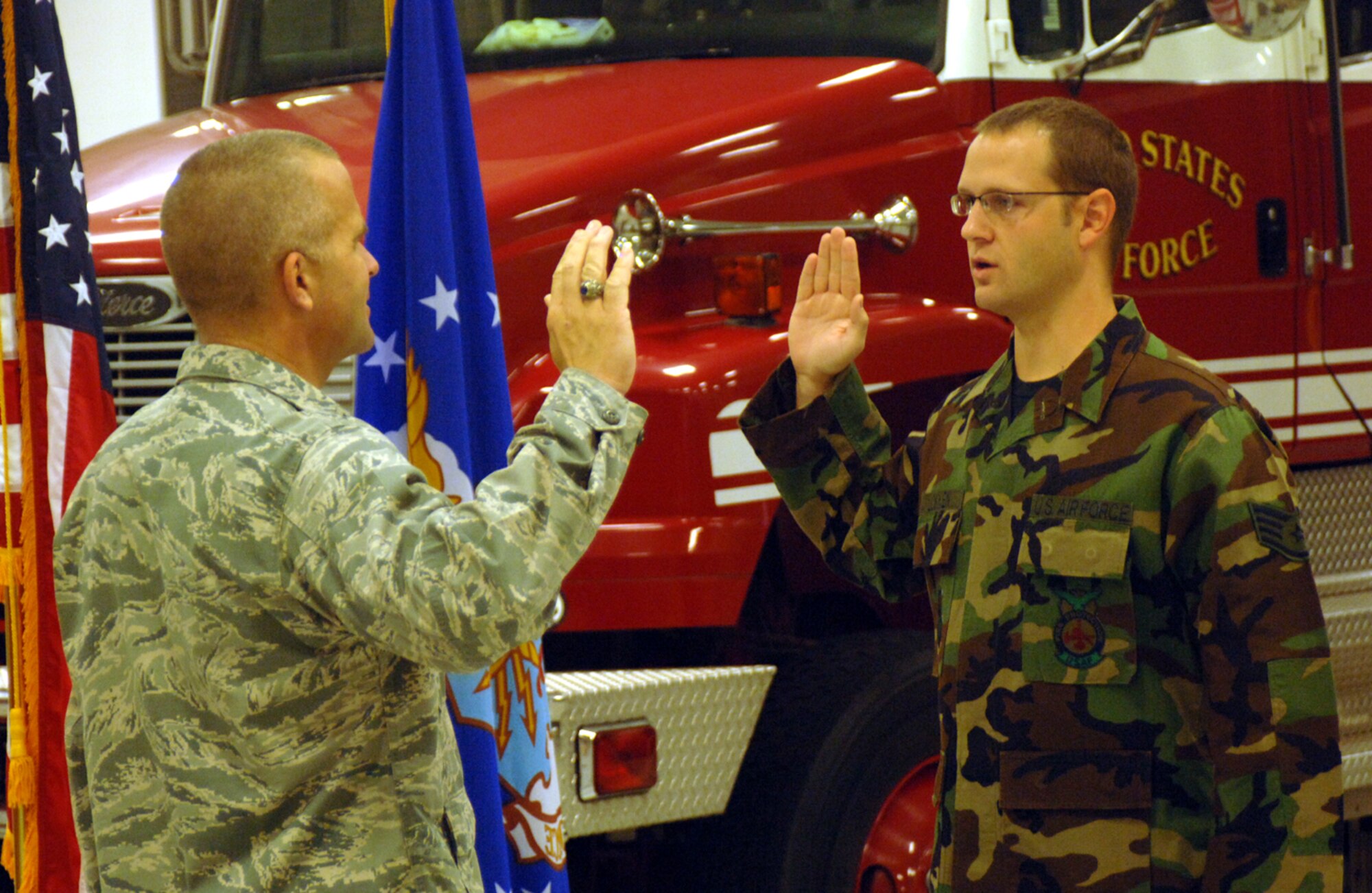 Staff Sgt. David Lokken, 14th Civil Engineer Squadron, takes the Oath of Enlistment from Lt. Col. Peter Ridilla, 14th CES commander. Sergeant Lokken reenlisted for an additional four years of service. (U.S. Air Force photo by Airman Josh Harbin) 