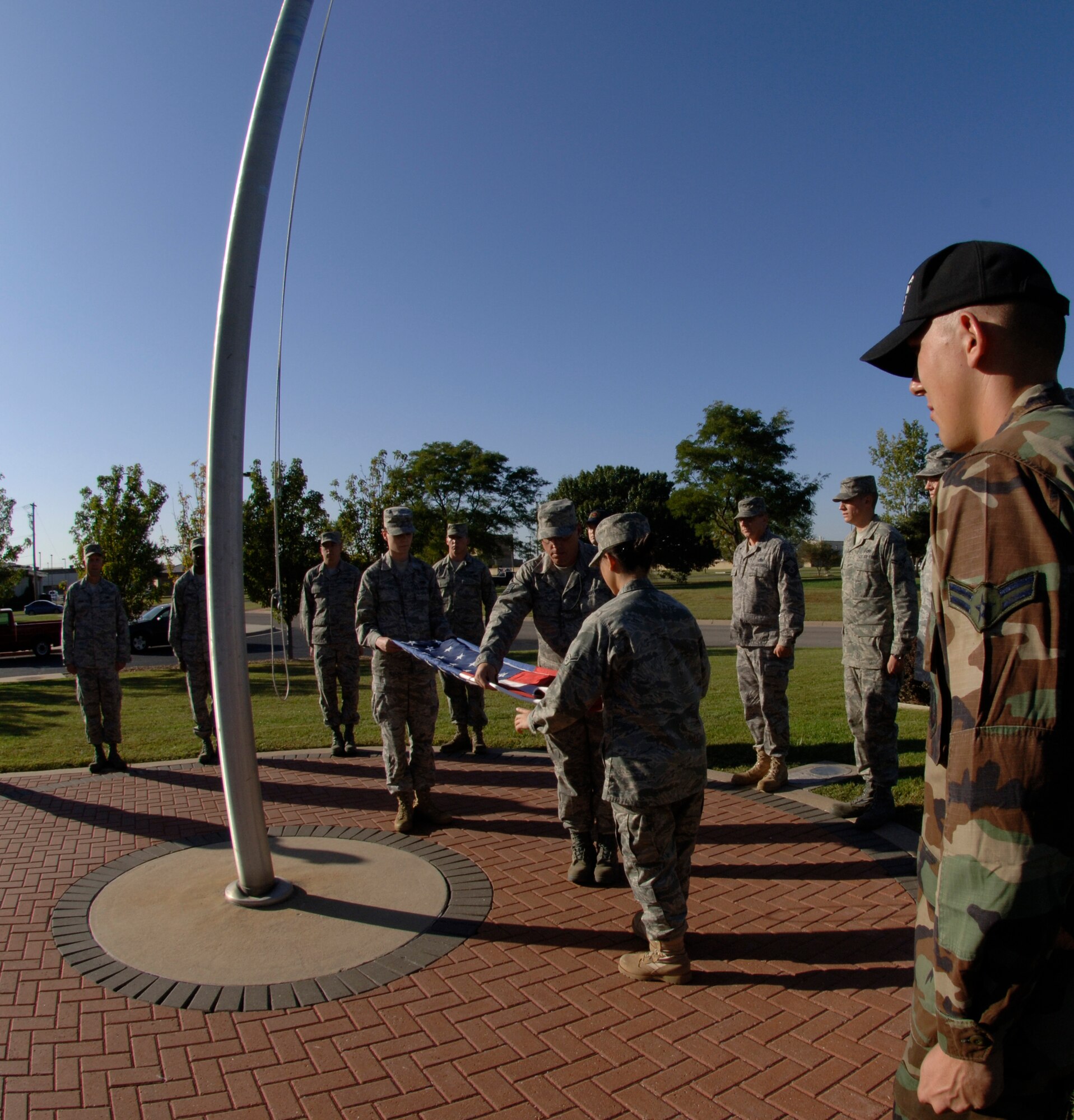 MCCONNELL AIR FORCE BASE, Kan. -- 22nd Maintenance Operations Squadron members provide their service during a retreat ceremony held outside the wing headquarters building, Oct. 2. Retreat ceremonies started in the American Army during the Revolutionary War and have continued since then throughout all branches of the military. (Photo by Senior Airman Laura Suttles)