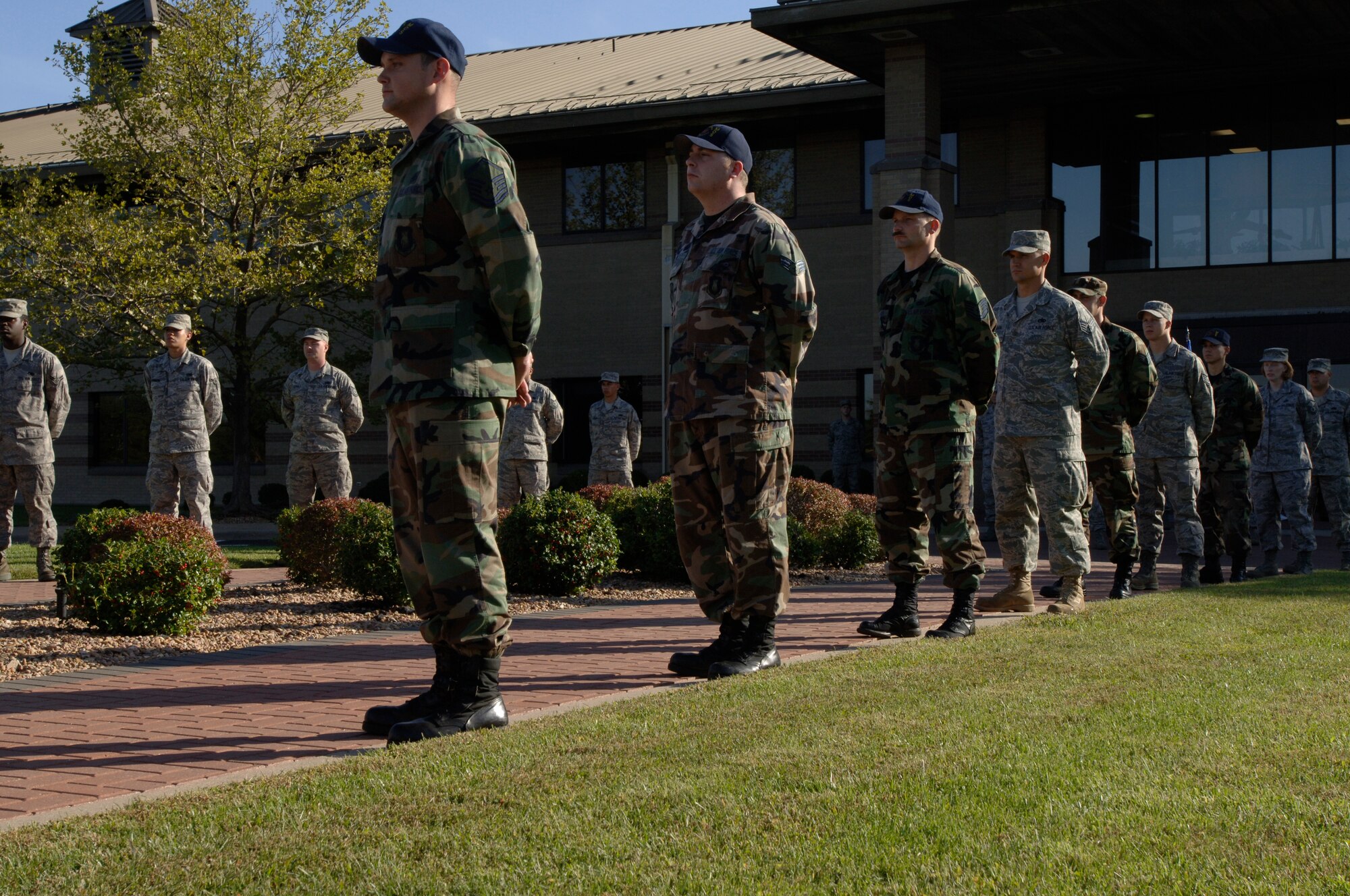 MCCONNELL AIR FORCE BASE, Kan. -- 22nd Maintenance Operations Squadron Airmen await the sound of retreat in a flag folding ceremony outside wing headquarters, Oct. 2. The 22nd Maintenance Operations Squadron performed a retreat ceremony in honor of the little heroes within their families that have supported their deployed parents. (Photo by Senior Airmen Laura Suttles)