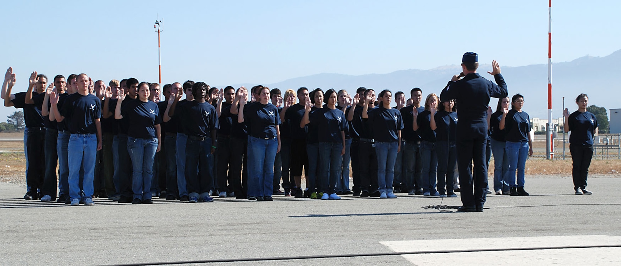 A U.S. Air Force Thunderbirds pilot administers the oath of enlistment for 54 new members of the 364th Recruiting Squadron Delayed Entry Program during a swearing in ceremony Sept. 27 at the California International Air Show in Salinas. In addition to affirming the dedication of the future Airmen to serve their nation, the public ceremony drew the attention of air show enthusiasts, and members of the 364th RCS were on hand to answer questions and share information about Air Force job opportunities. (U.S. Air Force photo/Staff Sgt. Justin Gress)