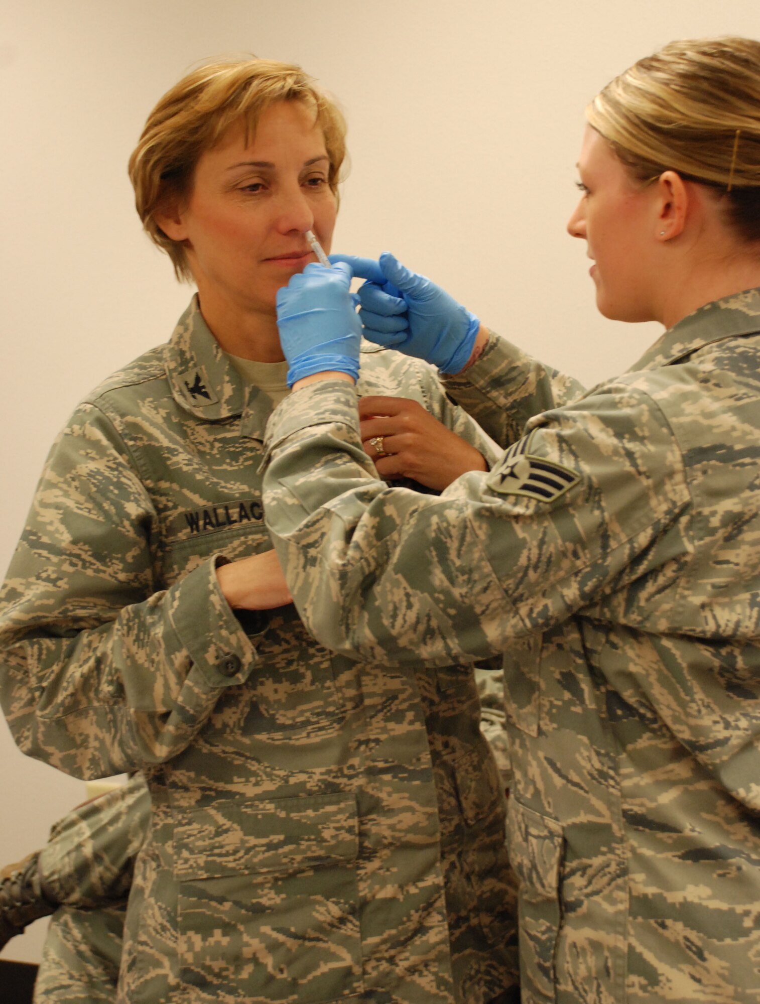 Senior Airman Brittany Deziel, a medical technician in the 82nd Medical Operations Squadron, gives Col. Janice Wallace, deputy commander for the 82nd MDOS, her flu vaccination with a nasal spray. Medical technicians began administering flu vaccinations to Sheppard personnel Oct. 8 to prepare for the upcoming flu season. (U.S. Air Force photo/Airman 1st Class Candy Miller)