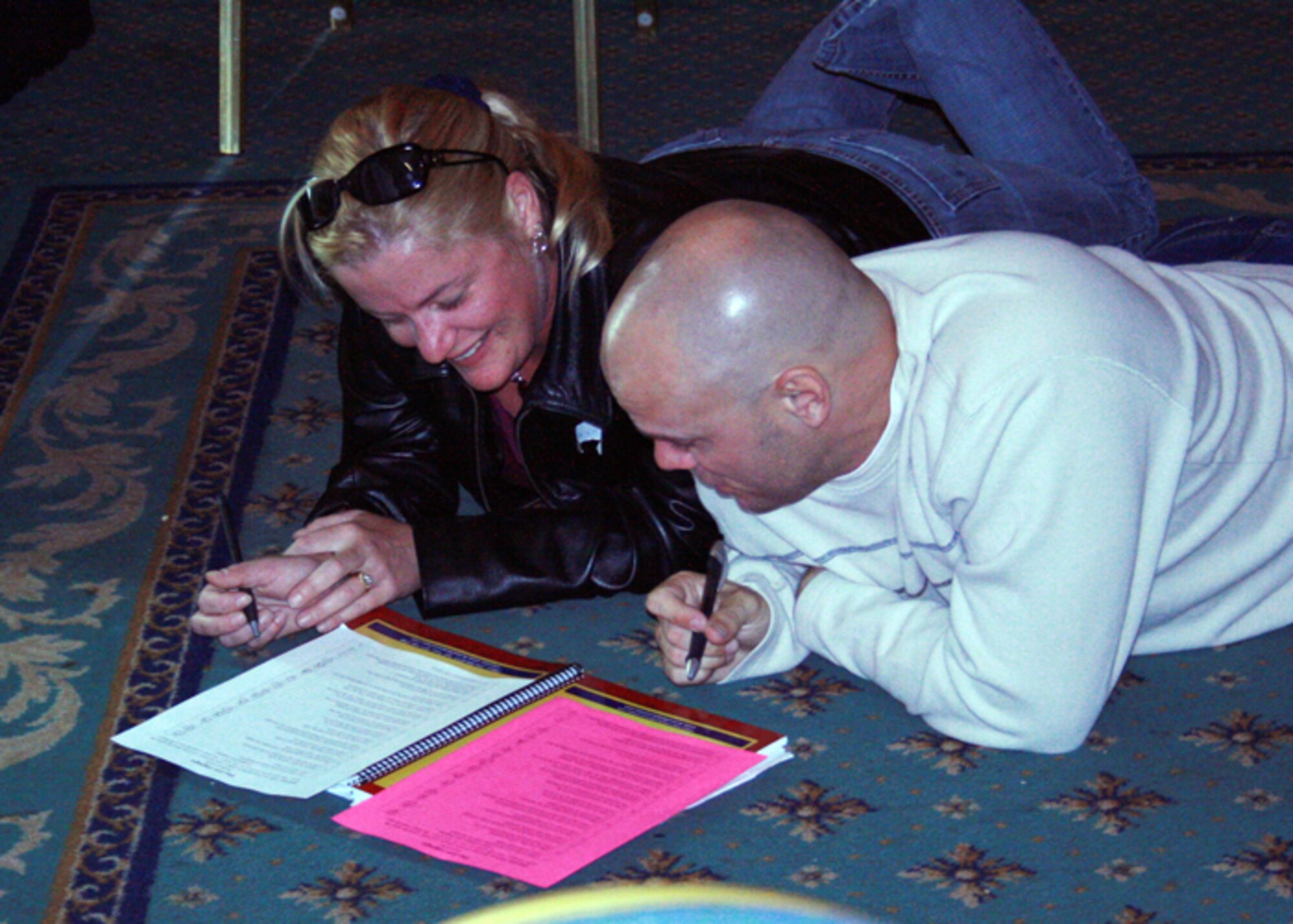 Shawna and Jason Ray laugh together while figuring out each other's individual "love language" at the Marriage Reintegration Retreat in Norwich, England. The retreat is designed to help couples reconnect and become better communicators to assist with the separation that occurs during deployments. (Courtesy photo)