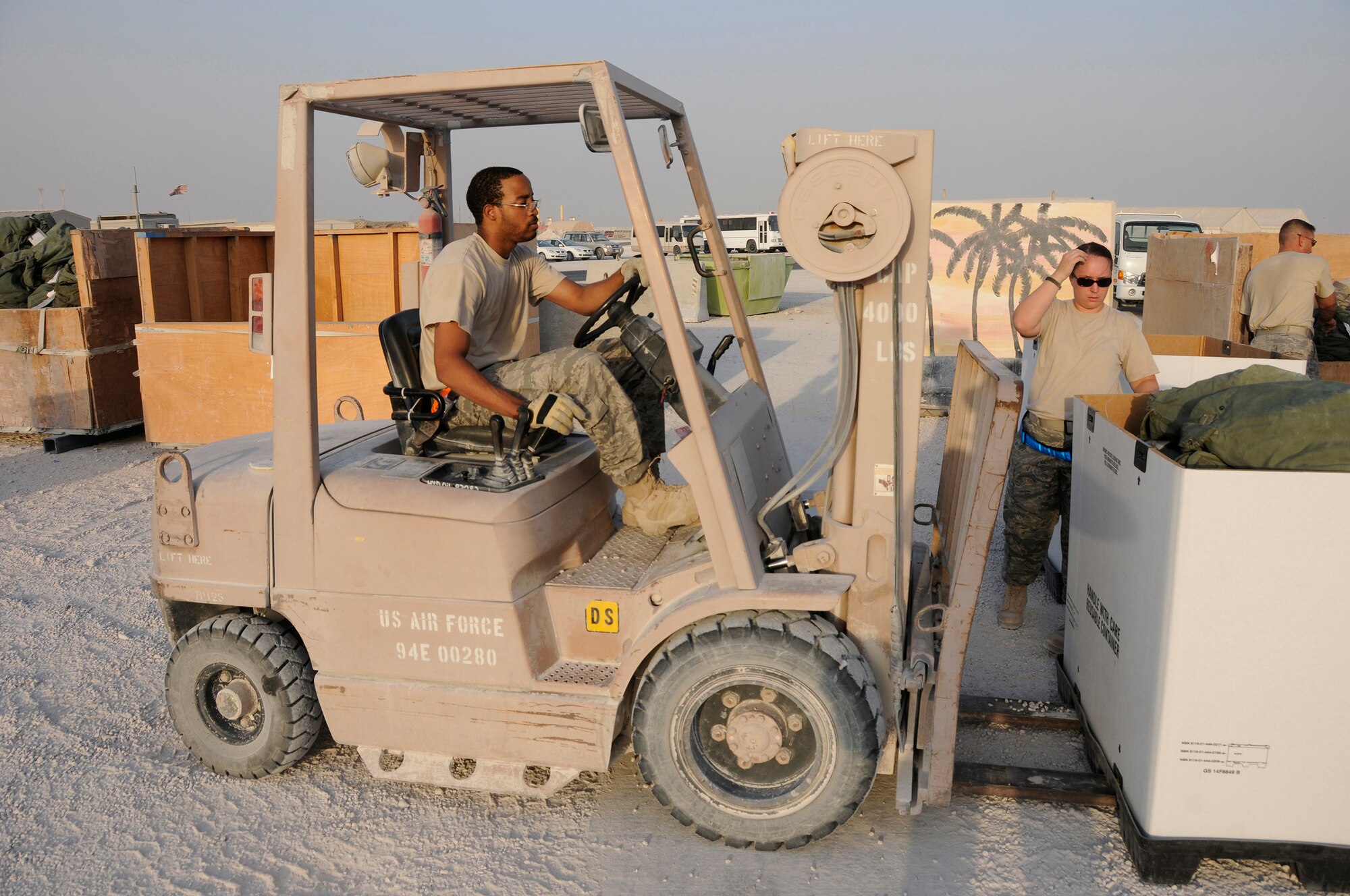 Senior Airman Jerome Bryant, 379th Expeditionary Logistics Readiness Squadron, uses a forklift to move a box of C-bags October 8, 2008.  The C-bag contains sealed chemical gear, including overgarment suits, gloves, boots, gas mask canisters and M-291 decontamination kits.  The bags are returned items from Airmen rotating back to home stations after completing their deployments.  The bags are sorted by size and stored here at an undisclosed air base in Southwest Asia.  Airman Bryant, a native of Little Rock, Ark., is deployed from Shaw Air Force Base, S.C., in support of Operations Iraqi and Enduring Freedom and Joint Task Force-Horn of Africa.  (U.S. Air Force photo by Tech. Sgt. Michael Boquette/Released)