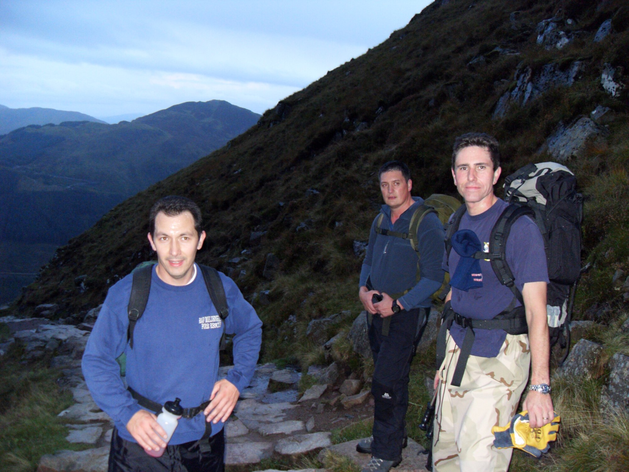 (From left to right) Defence Fire Service Firefighter Alan Coldwell, 100th Civil Engineer Squadron Fire Department, Dave Wainwright, 100th Force Support Squadron Outdoor Recreation, and Defence Fire Service Firefighter Chris Gould, also 100th CES Fire Department, pose for a photo half-way up Ben Nevis, Scotland. Ben Nevis was the first of three mountains they climbed Oct. 2 and 3 for the Three Peaks Challenge, to raise money for charity. The men also climbed Scaffel Pike, England, and Mount Snowdon, Wales. At the top of Mount Snowdon, where they finished their original challenge, they found a new challenge when they came across a man who was unconscious and suffering from hypothermia and frostbite. They called emergency services and played a big part in getting him rescued from the mountain and taken to the hospital. ((Photo by Firefighter Jerry Myles)