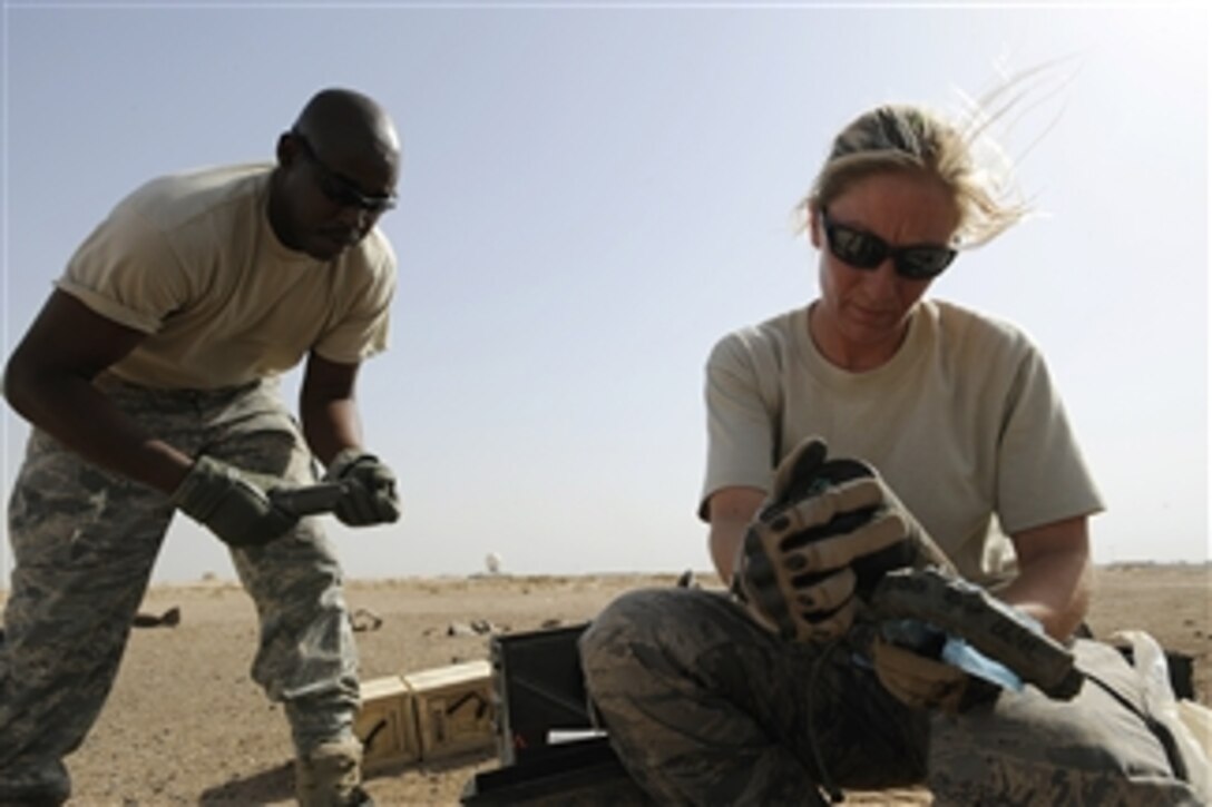 U.S. Air Force Master Sgt. Gerald Davis and Staff Sgt. Mesa Anderson identify unserviceable munitions before disposing of them through a controlled detonation at Joint Base Balad, Iraq, on Oct. 8, 2008.  The numbers and types of munitions are carefully monitored to ensure no ordnance is left on the range.  Both airmen are assigned to the 332nd Expeditionary Civil Engineer Squadron Explosive Ordnance Disposal team.  