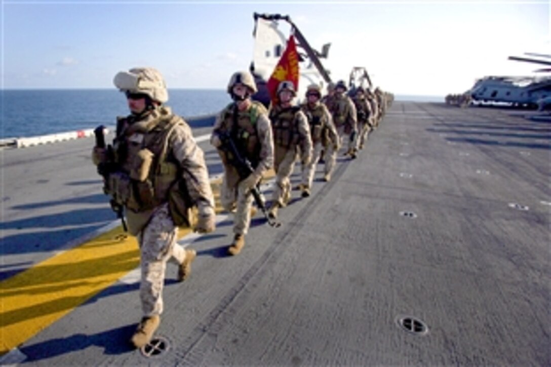 U.S. Marines and sailors assigned to Fox Company, Battalion Landing Team 2/6, 26th Marine Expeditionary Unit, participate in a 5-kilometer conditioning march on the flight deck of the amphibious assault ship USS Iwo Jima. Arabian Sea, Oct. 7, 2008. The 26th Marine Expeditionary Unit is deployed in the Central Command area of responsibility aboard the ships of the Iwo Jima Strike Group promoting stability in the region.