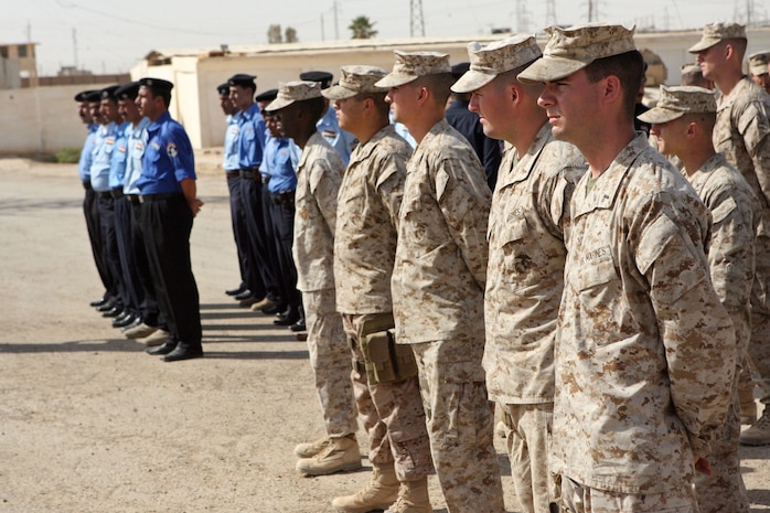 Marines of 1st Battalion, 9th Marine Regiment, Regimental Combat Team 1 and 2nd Bn., 9th Marines, RCT-1, stand in formation with their Iraqi police counterparts during the battalions’ relief-in-place ceremony in Ramadi, Iraq, Oct. 9. (Official Marine Corps Photo by Lance Cpl. Jerry Murphy) (Released)