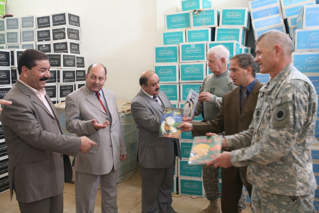 RAMADI, Iraq -- Service members with the embedded Provincial Reconstruction Team, Regimental Combat Team 1, meet with the Mayor and the Deputy of Education for Ramadi, Iraq, to donate educational books to local schools throughout the city Oct. 9. (Official Marine Corps photo by Cpl. Chris T. Mann) (Released)