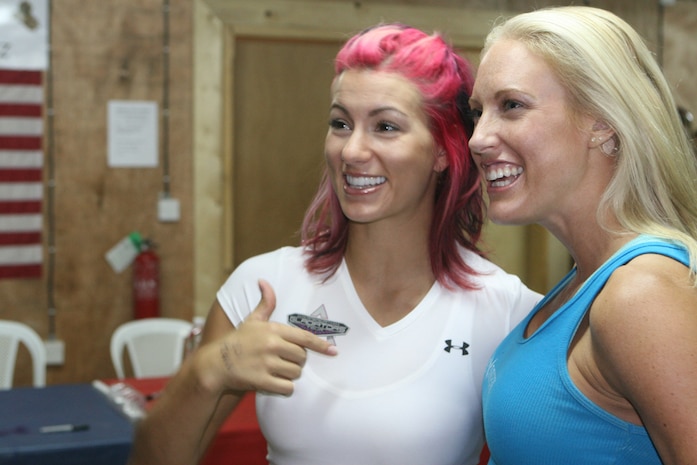 Phoenix and Venom, gladiators from the TV series "American Gladiators," pose for a photo in the gym on Combat Outpost Rawah, Iraq, Oct. 9. Along with these two athletes came other gladiators from the show, Titan, Militia and Panther to visit service members.