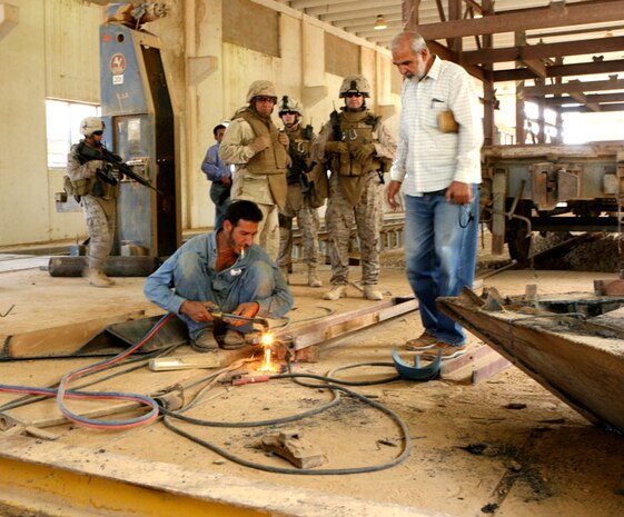 An Iraqi welder welds together pieces of a blower which will be mounted on the front of trains at Haqlaniyah, Iraq, Oct.10.  Civil Affairs Team 6, Detachment 1, 2nd Battalion, 11th Marine Regiment, Regimental Combat Team 5 has worked with Iraqi contractors to renovate the train station in Haqlaniyah.  The trains will transport crude oil that will be refined into different products for the people of al-Anbar province, Iraq.