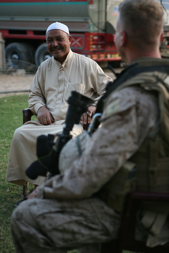 Sobhy Humady Khatlan, a Rawah, Iraq, resident and businessman, speaks with 2nd Lt. Randy Blowers, platoon commander, Provisional Rifle Platoon 3, during a brief visit Oct. 10 at his home in Rawah. Blowers and his Marines were meeting neighbors in the area around Traffic Control Point 3, the new home of PRP 3, to build relationships with the citizens.::r::::n::