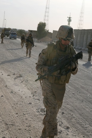 Patrolling near Traffic Control Point 3 in Rawah, Iraq, Marines from Provisional Rifle Platoon 3 provide security for the areas around the Rawah Bridge that crosses the Euphrates River Dec. 1.  Seaman Nick Vassiliades, right, has the duty of ensuring immediate medical support is available to the Marines each time they are "outside the wire."::r::::n::