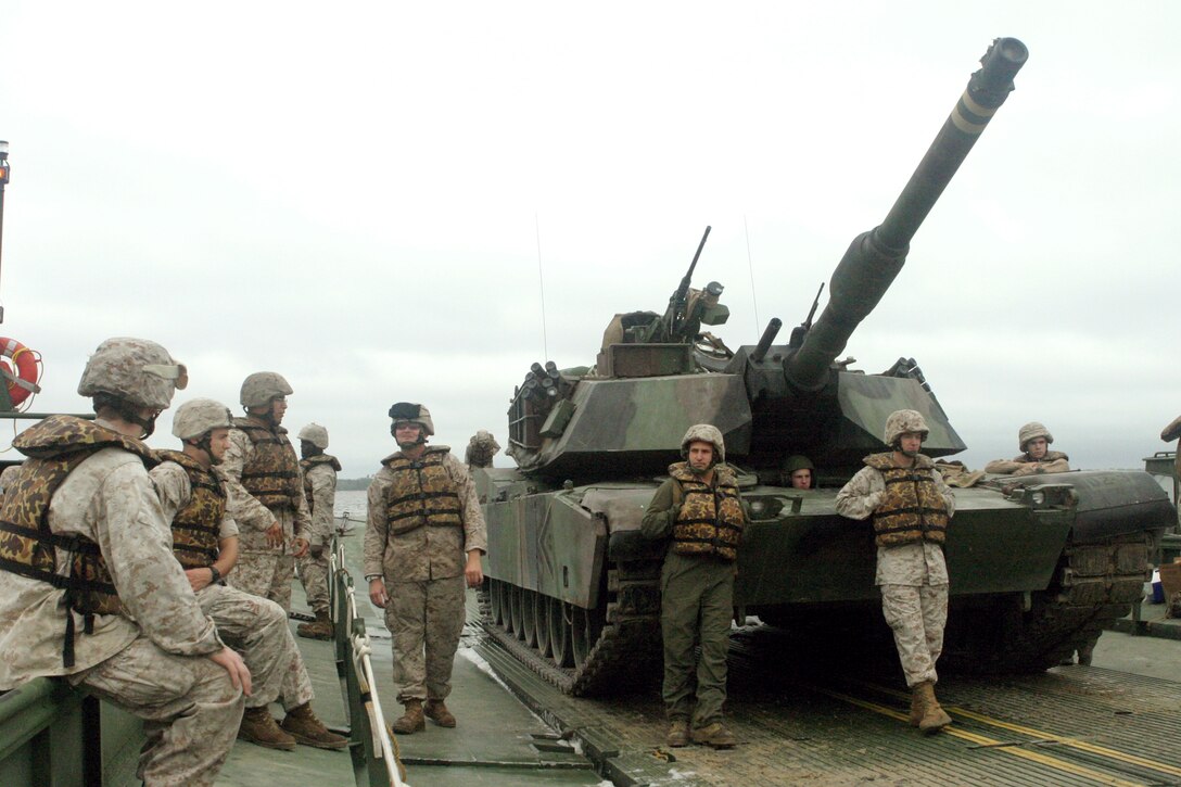 An M1A1 Abrams tank from Delta Company, 2nd Tank Battalion, 2nd Marine Division rests on a raft from Bridge Company, 8th Engineer Support Battalion, 2nd Marine Logistics Group as it makes its way across the New River on Oct. 10.  The companies conducted a river-crossing exercise to get tanks across the river and hone their skills.