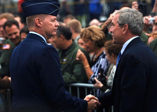 Col. John "Red" Millander shakes President George Bush's hand upon his arrival to Charleston Air Force Base, S.C., Oct. 10. President Bush met with more than 250 Team Charleston members en route to an event at Kiawah Island, S.C. Colonel Millander is the commander of the 437th Airlift Wing.  (U.S. Air Force photo/Airman 1st Class Timothy Taylor)

