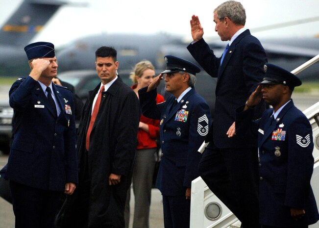 Col. John "Red" Millander salutes President George Bush upon his arrival to Charleston Air Force Base, S.C., Oct. 10. President Bush met with more than 250 Team Charleston members en route to an event at Kiawah Island, S.C. Colonel Millander is the commander of the 437th Airlift Wing.  (U.S. Air Force photo/Airman 1st Class Timothy Taylor)