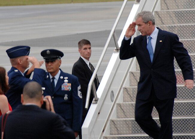 President George Bush salutes Col. John "Red" Millander on the Charleston Air Force Base, S.C., flightline Oct. 10. President Bush met with more than 250 Team Charleston members en route to an event at Kiawah Island, S.C. Colonel Millander is the 437th Airlift Wing commander. (U.S. Air Force photo/Airman 1st Class Katie Gieratz)