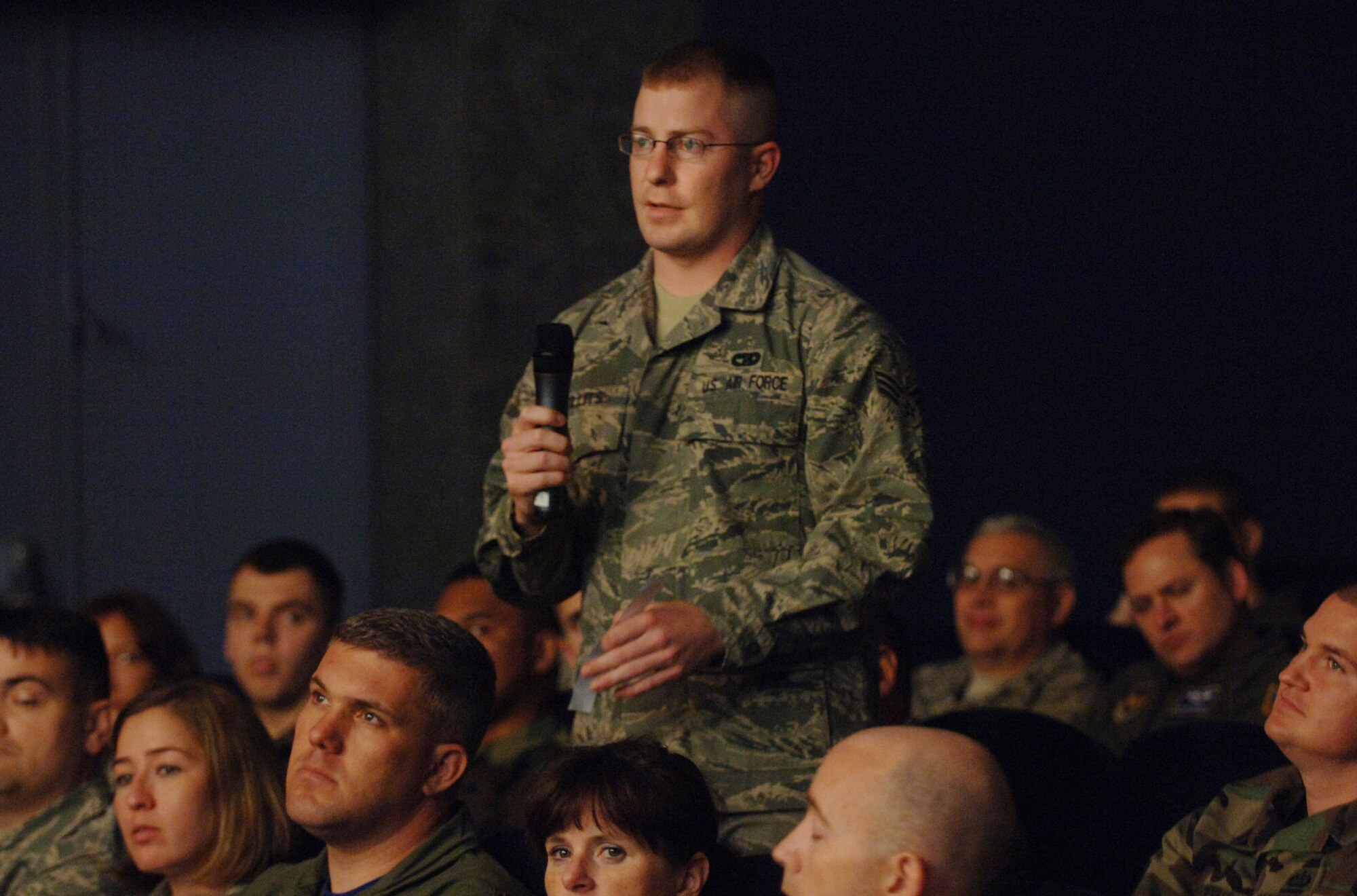 Senior Airman Cory Willits poses a question to Secretary of the Air Force Michael B. Donley Oct. 10 during a townhall meeting at Ramstein Air Base, Germany. The secretary  spoke to a crowd of more than 300 Airmen about the service's newest initiatives and priorities. Airman Willits is an air transportation specialist assigned to the 86th Air Mobility Squadron at Ramstein. (DOD photo/Master Sgt. Scott Wagers)