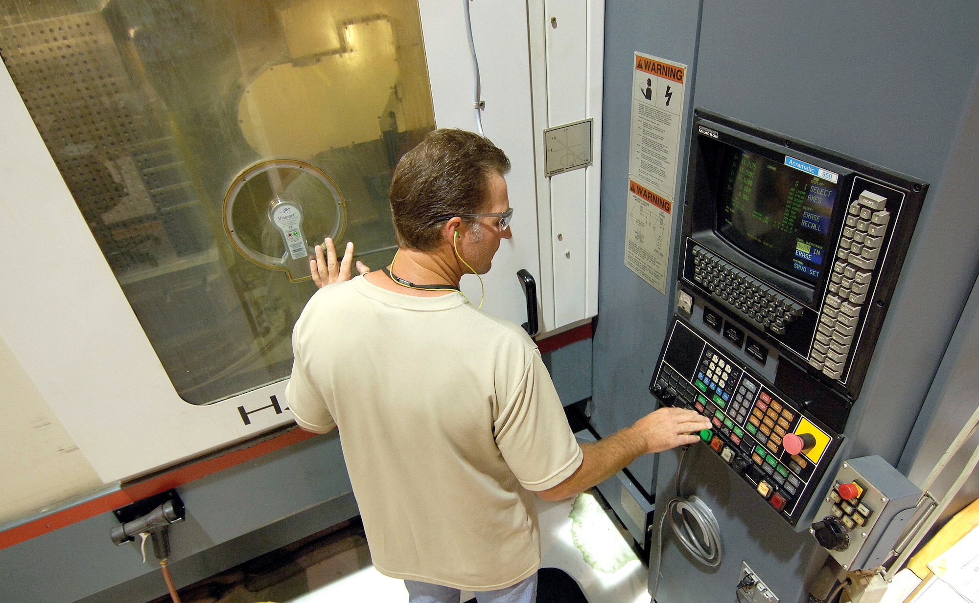 Paul Spurlock monitors a B-1B Lancer part being manufactured Oct. 2 at Tinker Air Force Base, Okla. Mr. Spurlock is a numerical controlled machining cell machinist. (U.S. Air Force photo/Margo Wright)