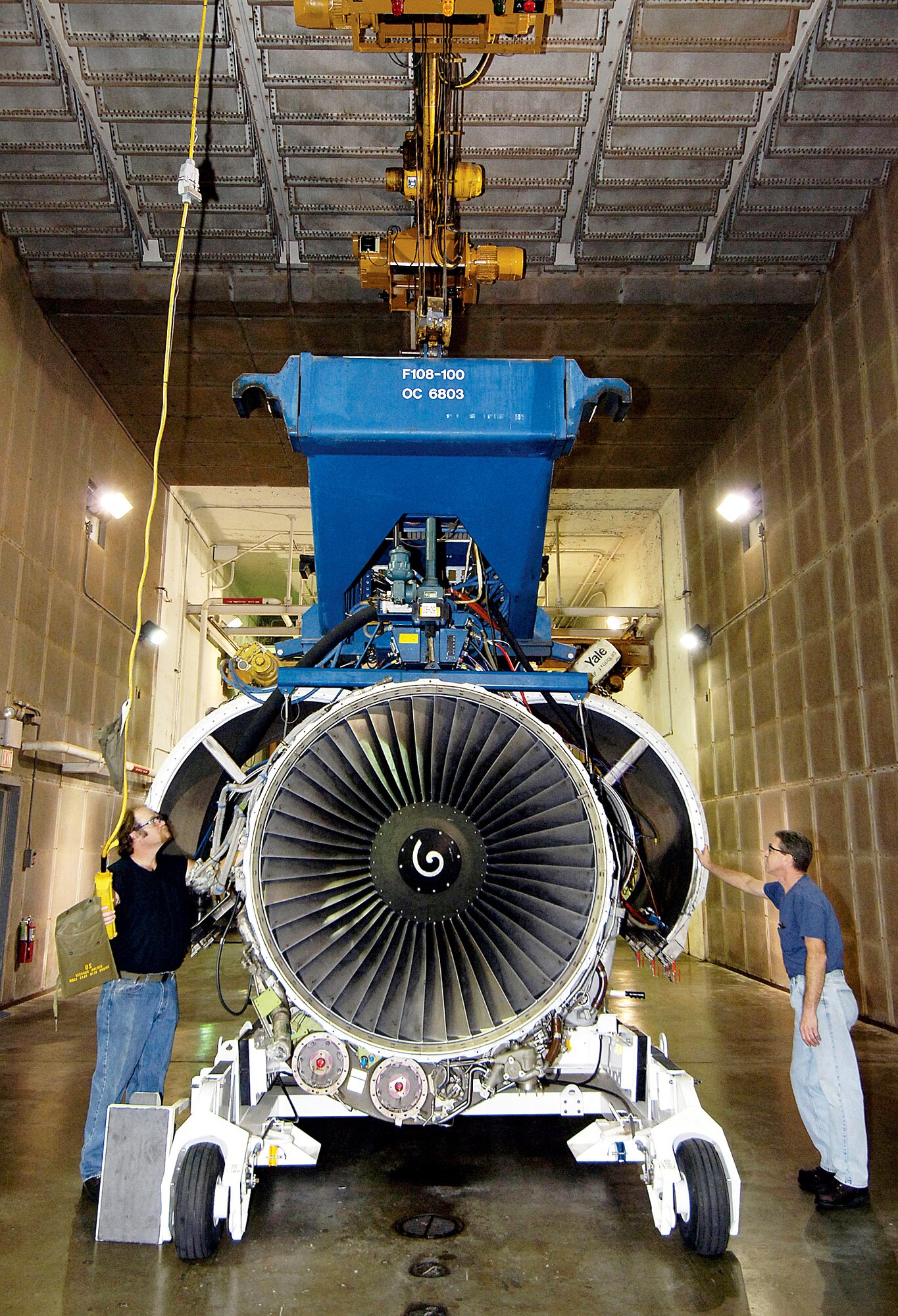 An F108-200 engine is moved by Steve Marlett (left) and William LeRoy after testing at the engine test cell of the 76th Propulsion Maintenance Group Oct. 2 at Tinker Air Force Base, Okla. (U.S. Air Force photo/Margo Wright) 
