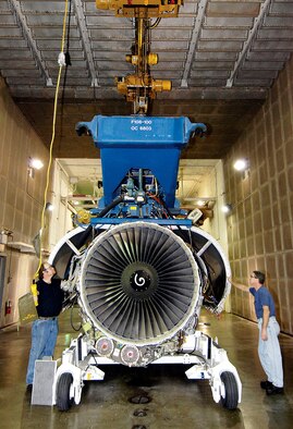 An F108-200 engine is moved by Steve Marlett (left) and William LeRoy after testing at the engine test cell of the 76th Propulsion Maintenance Group Oct. 2 at Tinker Air Force Base, Okla. (U.S. Air Force photo/Margo Wright) 