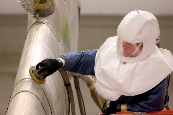 Anthony Hunt scuff sands a KC-10 Extender while 60-feet high in the Corrosion Control Facility Hangar Oct. 2 at Tinker Air Force Base, Okla. Aircraft are worked non-stop by each shift as they are depainted, prepared and repainted by crews of the 76th Aircraft Maintenance Group. (U.S. Air Force photo/Margo Wright) 