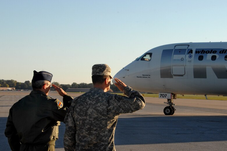OFFUTT AIR FORCE BASE, Neb. -- Colonel Robert L. Maness, vice commander 55th Wing, along with Maj. Gen. Carroll F. Pollett, deputy chief of staff U.S. Strategic Command, salute departing CAPSTONE attendees as they prepare to depart Offutt AFB, Neb., following a three-day tour of U.S. Strategic Command Headquarters, Oct. 10.  CAPSTONE is a Department of Defense joint service professional military education course for newly promoted brigadier generals and rear admirals serving in the U.S. military. (U.S. Air Force Photo By Josh Plueger)