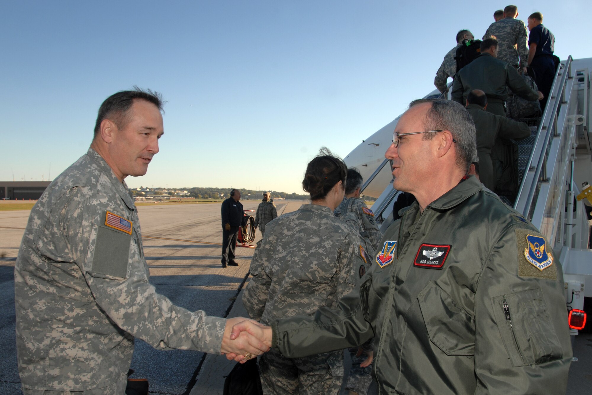 OFFUTT AIR FORCE BASE, Neb. -- Colonel Robert L. Maness, vice commander 55th Wing, bids farewell to members of the CAPSTONE tour as they board an aircraft to continue their multiple base tour.  Attendees went on a three-day tour at U.S. Strategic Command Headquarters prior to departing Offutt AFB, Neb., Oct 10.  CAPSTONE is a Department of Defense joint service professional military education course for newly promoted brigadier generals and rear admirals serving in the U.S. military. (U.S. Air Force Photo By Josh Plueger)