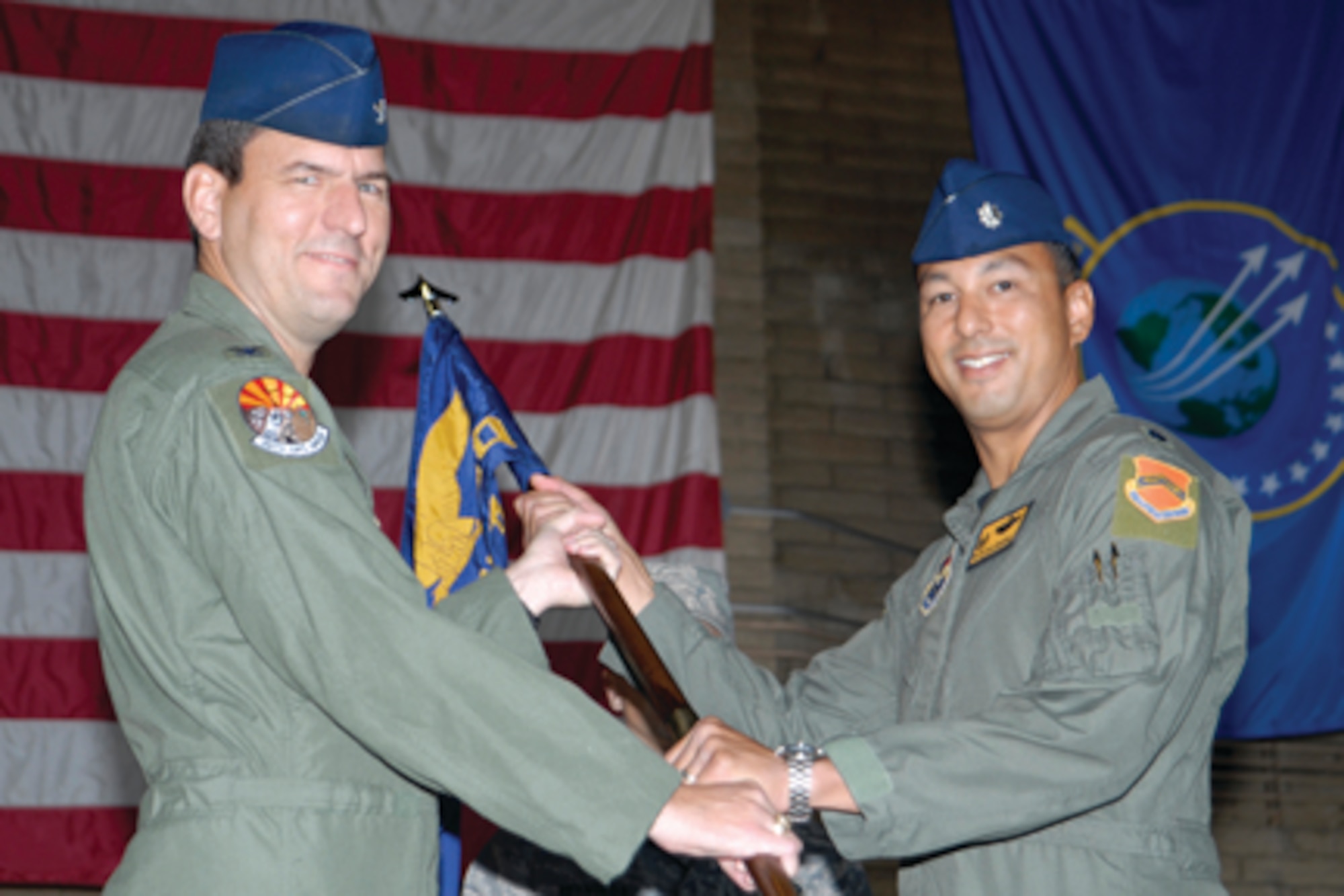 Lt. Col. Philippe Malebranche speaks to the audience after taking command of the 61st Fighter Squadron from Lt. Col. James Sears during a ceremony Monday in Hangar 485. Colonel Malebranche served previously at U.S. Forces Korea, Yongsan Army Garrison, as a political-military planning officer and chief of international relations. In May 2007, he returned to Luke for F-16 requalification and instructor pilot upgrade and served as 56th Training Squadron director of operations. He is originally from San Francisco, Calif. 

The 61st FS dates back to 1940 when it was constituted as the 61st Pursuit Squadron Nov. 20. It was activated Jan. 15, 1941, in Savannah, Ga., and reactivated at Luke April 1, 1994. (U.S. Air Force photo/Master Sgt. William Gomez.)
