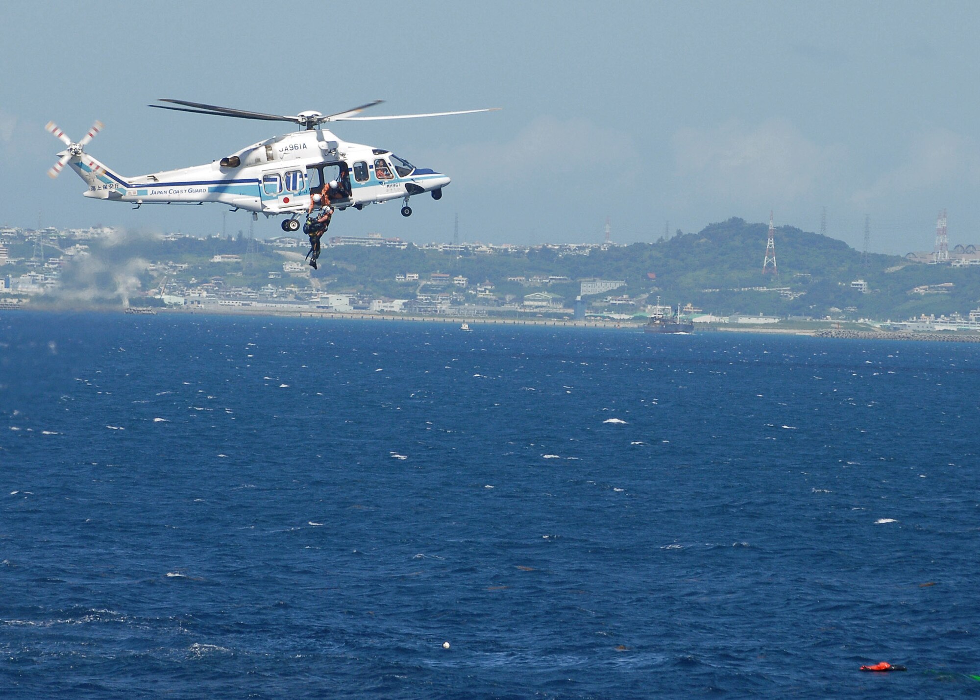 Japanese coast guard members rescue a downed pilot from a simulated F-15 Eagle crash during a crisis management exercise Oct. 8 off the coast of Okinawa, Japan. Members of the 18th Wing from Kadena Air Base, Japan, and the Japanese coast guard rehearsed response procedures for an over the water accident. (U.S. Air Force photo/Airman 1st Class Amanda Grabiec) 
