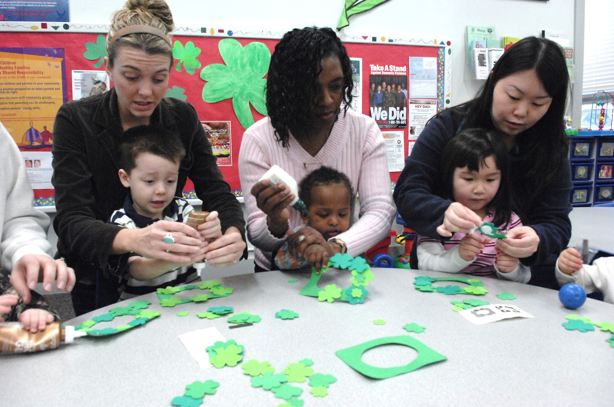 Parents help their children with a craft during a recent activity day at the Child Development Center. The CDC received funding for construction upgrades and training during the fiscal closeout Sept. 30. (U.S. Air Force photo/Abner Guzman)