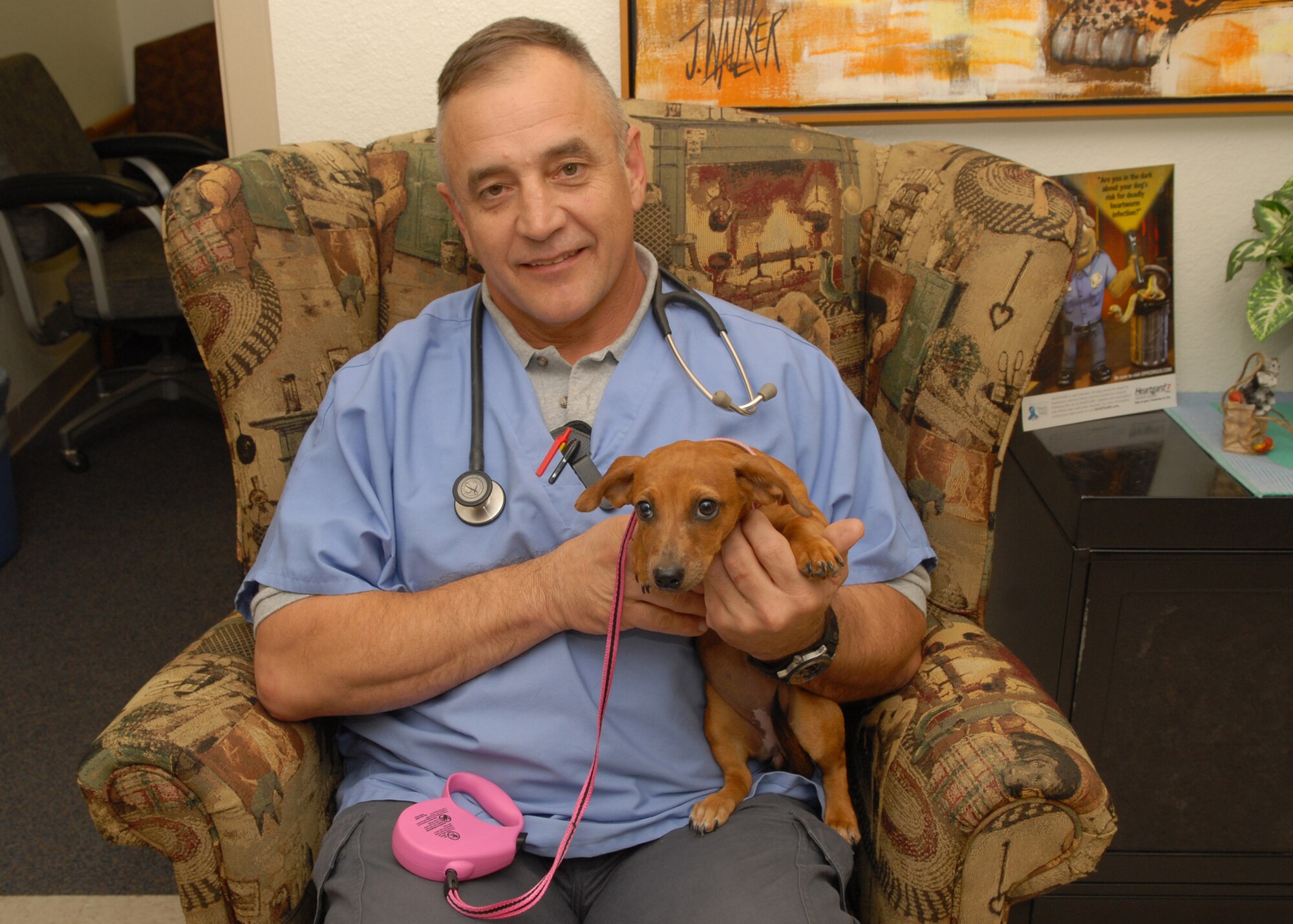 Army Capt. Tom Mason, 20th Special Forces Group, Army National Guard, takes a moment to pose with his patient Savannah during her recent visit to the Goodfellow Air Force Base veterinary clinic Oct. 1. The Goodfellow vet clinic is open for appointments from 9 a.m. - 3 p.m. Tuesdays. (U.S. Air Force photo by Senior Airman Kasabyan Musal)
