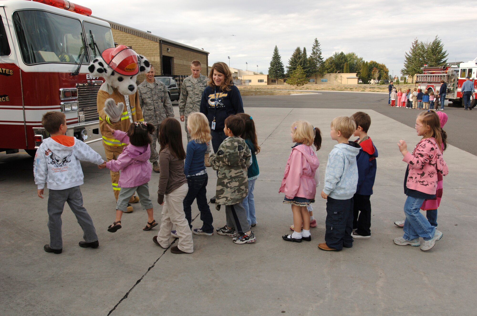 FAIRCHILD AIR FORCE BASE, Wash. – Sparky the Fire Dog greets an excited kindergarten class from Michael Anderson Elementary School as they arrive at the 92nd Civil Engineer Squadron fire station Oct. 3. The tour of the fire station kicked off Fire Prevention Week, Oct. 3 -10. The week was dedicated to teaching fire safety to children, kindergarten through sixth grade. (U.S. Air Force photo / Airman 1st Class Melissa Barnett)