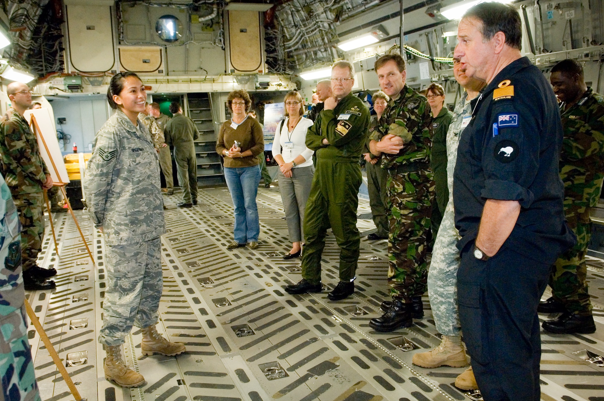 Staff Sgt. Kasie Spearman, 62nd Force Support Squadron, answers questions from foreign defense attachés concerning personnel readiness during a C-17 Globemaster III static display Wednesday in Hangar 4. The group was visiting McChord as part of the Fall 2008 Defense Attaché Operations Orientation Program that introduces the Foreign Defense Attachés to Defense Department and federal agency personnel, missions, facilities, training, weapons systems and capabilities, and exposes them to the industrial, historical and cultural aspects of American society. The program builds on the cooperation between the Defense Department and foreign militaries. McChord was included in a tour including a stop at Fort Lewis and several stops in Alaska.