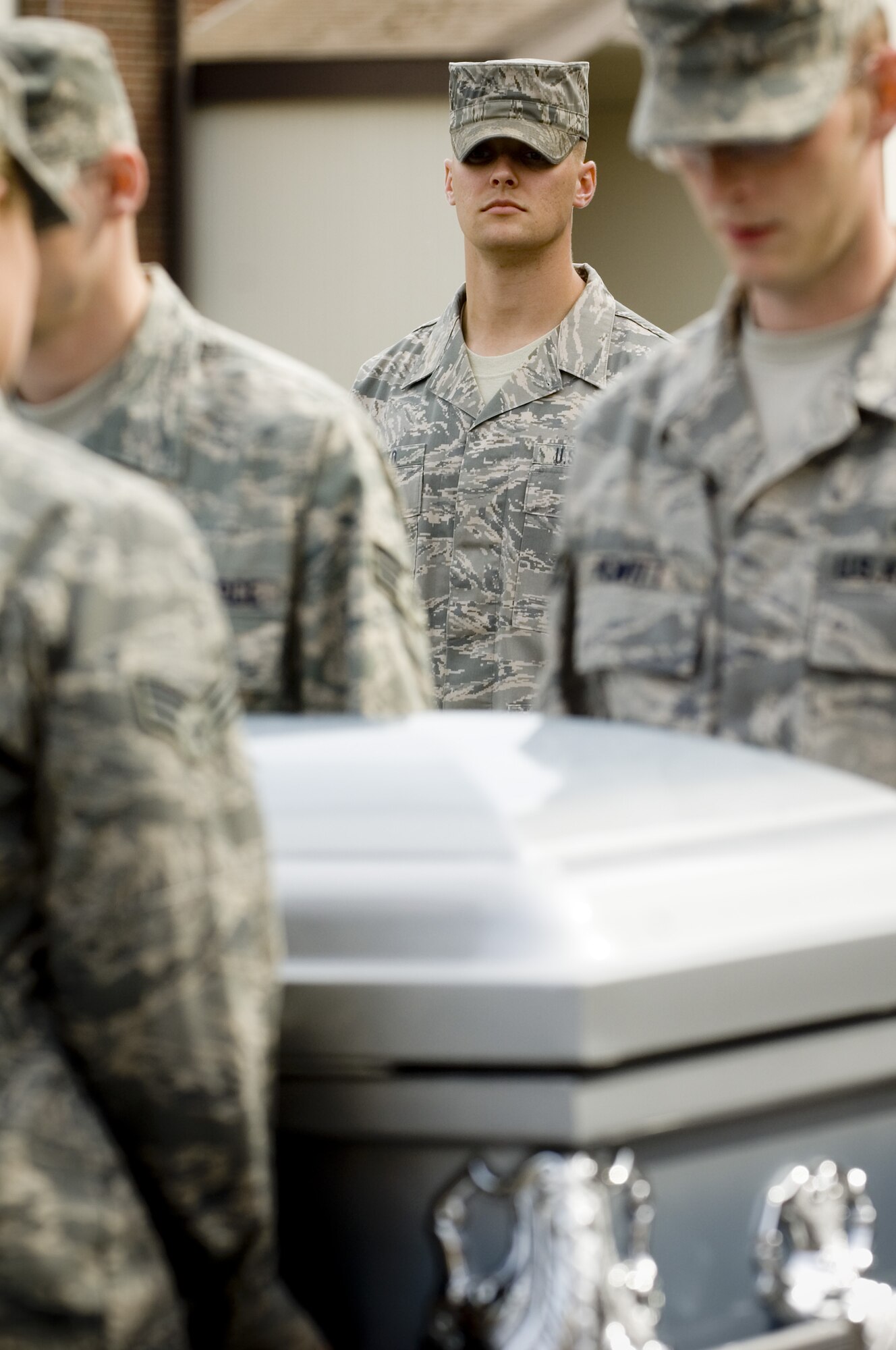 Staff Sgt. Alex Frizzo, U.S. Air Force Honor Guard formal training instructor, center, looks on as base honor guardsmen practice proper casket-carrying techniques during a recent visit to McChord Air Force Base, Washington. (Photo courtesy of U.S. Air Force Honor Guard)