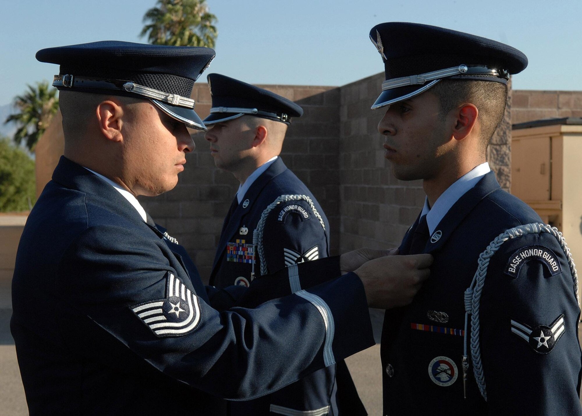Tech Sgt. Jason Estrada, U.S. Air Force Honor Guard noncommissioned officer in charge of the Base Honor Guard Training Program, inspects  a base honor guardsman’s dress uniform during a training visit to Davis-Monthan Air Force Base, Ariz. (Photo courtesy of U.S. Air Force Honor Guard)