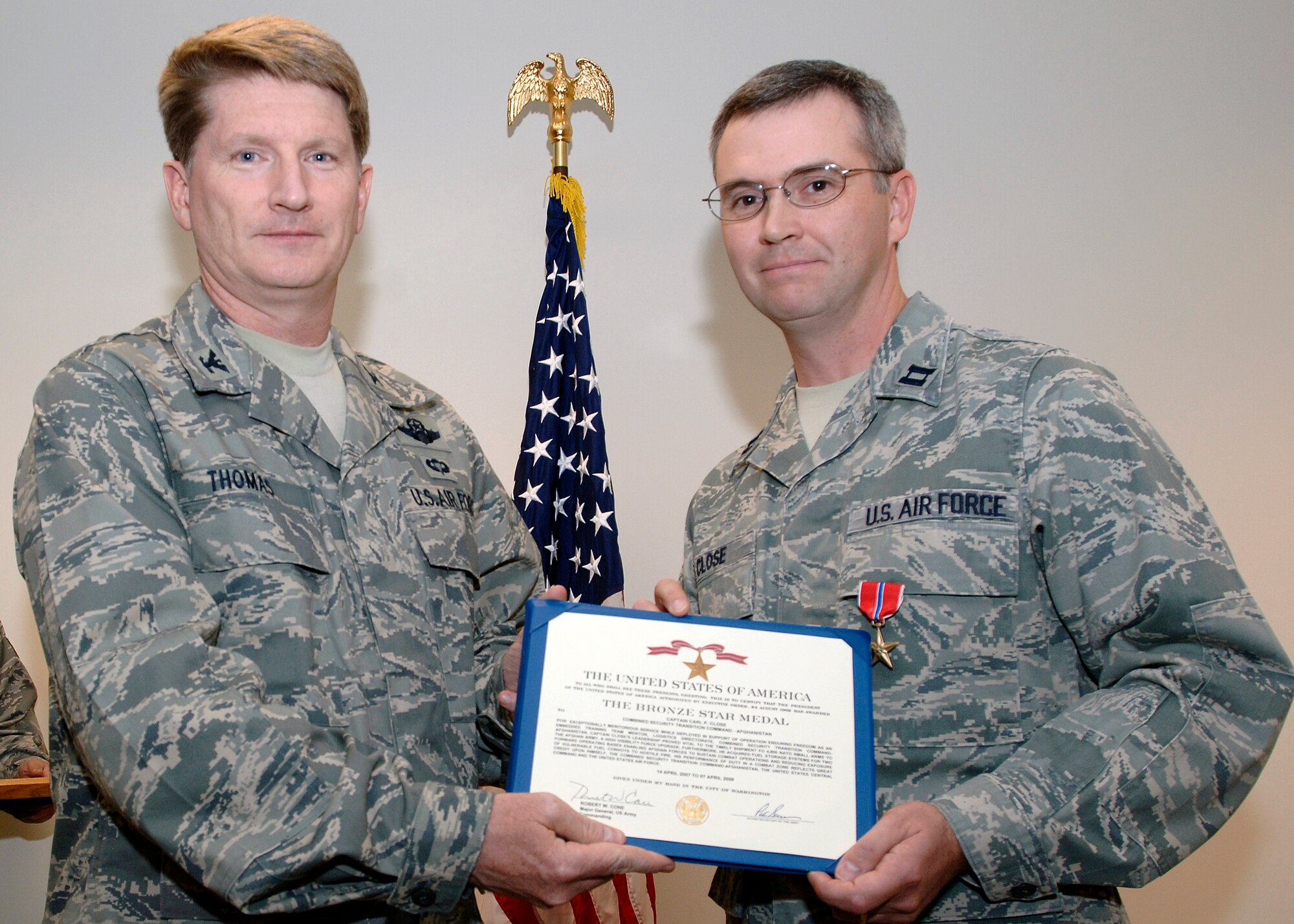 FAIRCHILD AIR FORCE BASE, Wash. – Capt. Carl Close (right), from the 92nd Logistic Readiness Squadron, and Col. Robert Thomas, 92nd Air Refueling Wing commander, pose with a Bronze Star medal certificate signifying Captain Closes’ meritorious service work while forward deployed to a combat environment. The captain received the medal for his service in Afghanistan April 2007 – April 2008, where he was the Embedded Training Team Senior Fuels Mentor for the Afghan National Army’s Forward Support Depot in Kandahar. (U.S. Air Force photo / Airman 1st Class Melissa Barnett)