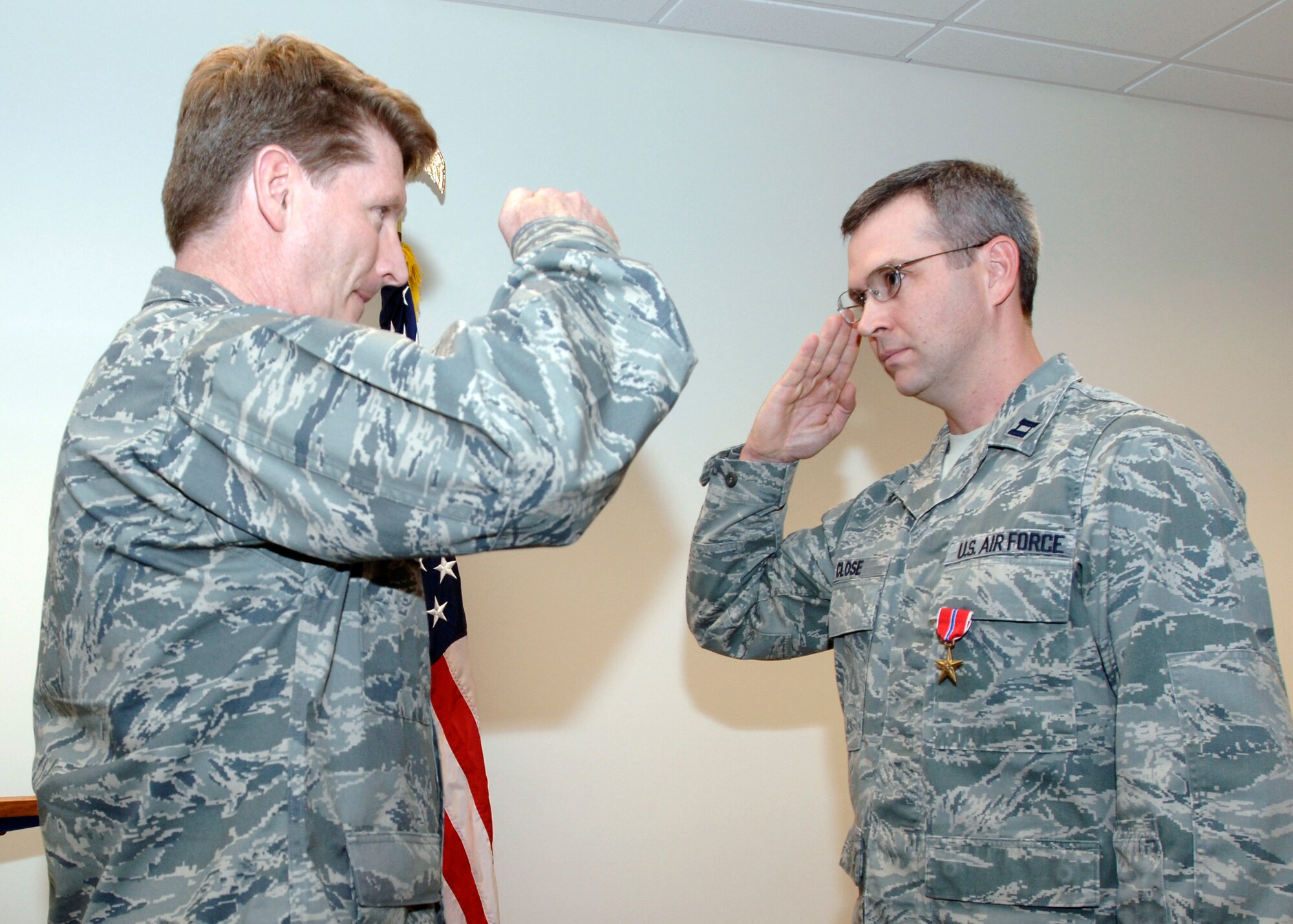 FAIRCHILD AIR FORCE BASE, Wash. – Capt. Carl Close (right), Bronze Star medal recipient from the 92nd Logistic Readiness Squadron, salutes Col. Robert Thomas, 92nd Air Refueling Wing commander, at his medal presentation ceremony at Fairchild Monday afternoon. The captain received the medal for his service in Afghanistan April 2007 – April 2008, where he was the Embedded Training Team Senior Fuels Mentor for the Afghan National Army’s Forward Support Depot in Kandahar. (U.S. Air Force photo / Airman 1st Class Melissa Barnett)