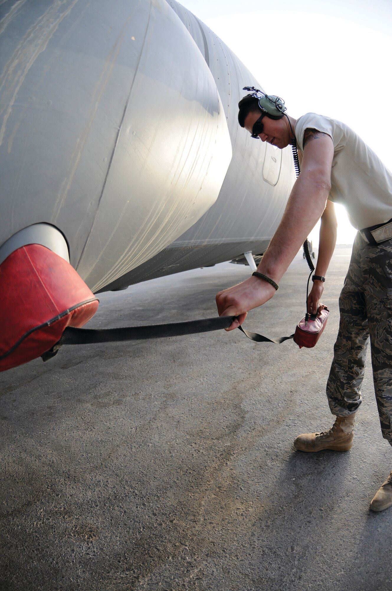 Airman 1st Class Joseph Marion, crew chief assigned to the 379th Expeditionary Aircraft Maintenance Squadron, removes the cargo compartment air conditioning plugs from a C-130J prior to take-off Sept, 29, 2008 at an undisclosed air base in Southwest Asia.  The EAMXS is responsible for providing maintenance to aircrafts prior to and after take-off so they can fly their mission in support of the global war on terrorism. Airman Marion, a native of Tampa, Fla., is deployed from Little Rock Air Force Base, Ark., in support of Operations Iraqi and Enduring Freedom and Joint Task Force-Horn of Africa. (U.S. Air Force photo by Staff Sgt. Darnell T. Cannady)
