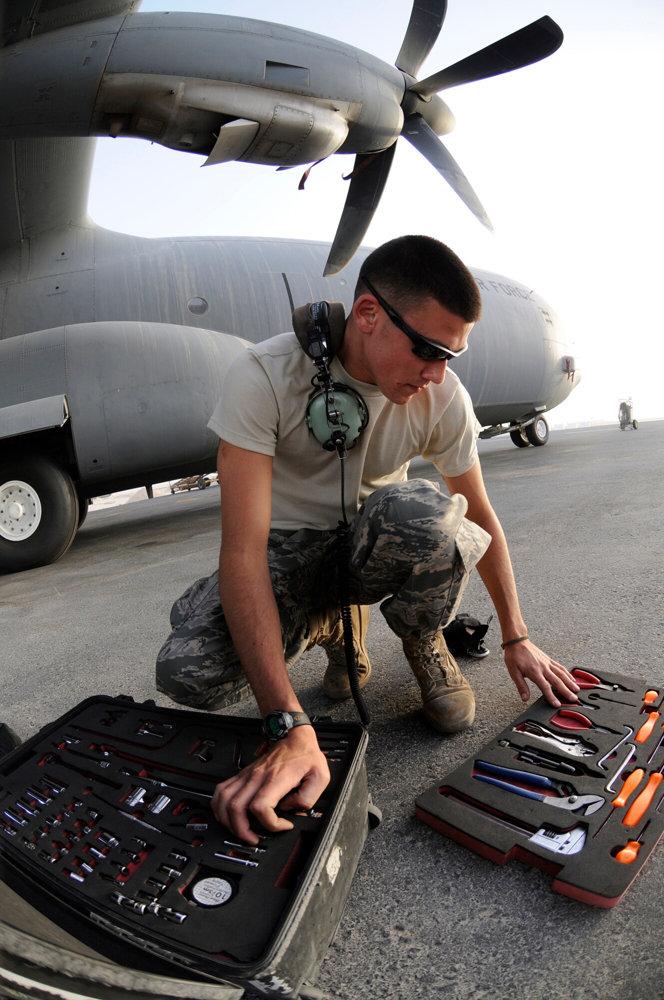 Airman 1st Class Joseph Marion, crew chief assigned to the 379th Expeditionary Aircraft Maintenance Squadron/746th Aircraft Maintenance Unit, prepares his tools prior to performing maintenance on a C-130J here Sept. 29. The unit is responsible for providing maintenance to aircraft before and after take-off enabling them to fly missions in support of the Global War on Terror. Airman Marion, a native of Tampa, Fla., is deployed from Little Rock Air Force Base, Ark. (U.S. Air Force photo by Staff Sgt. Darnell T. Cannady)