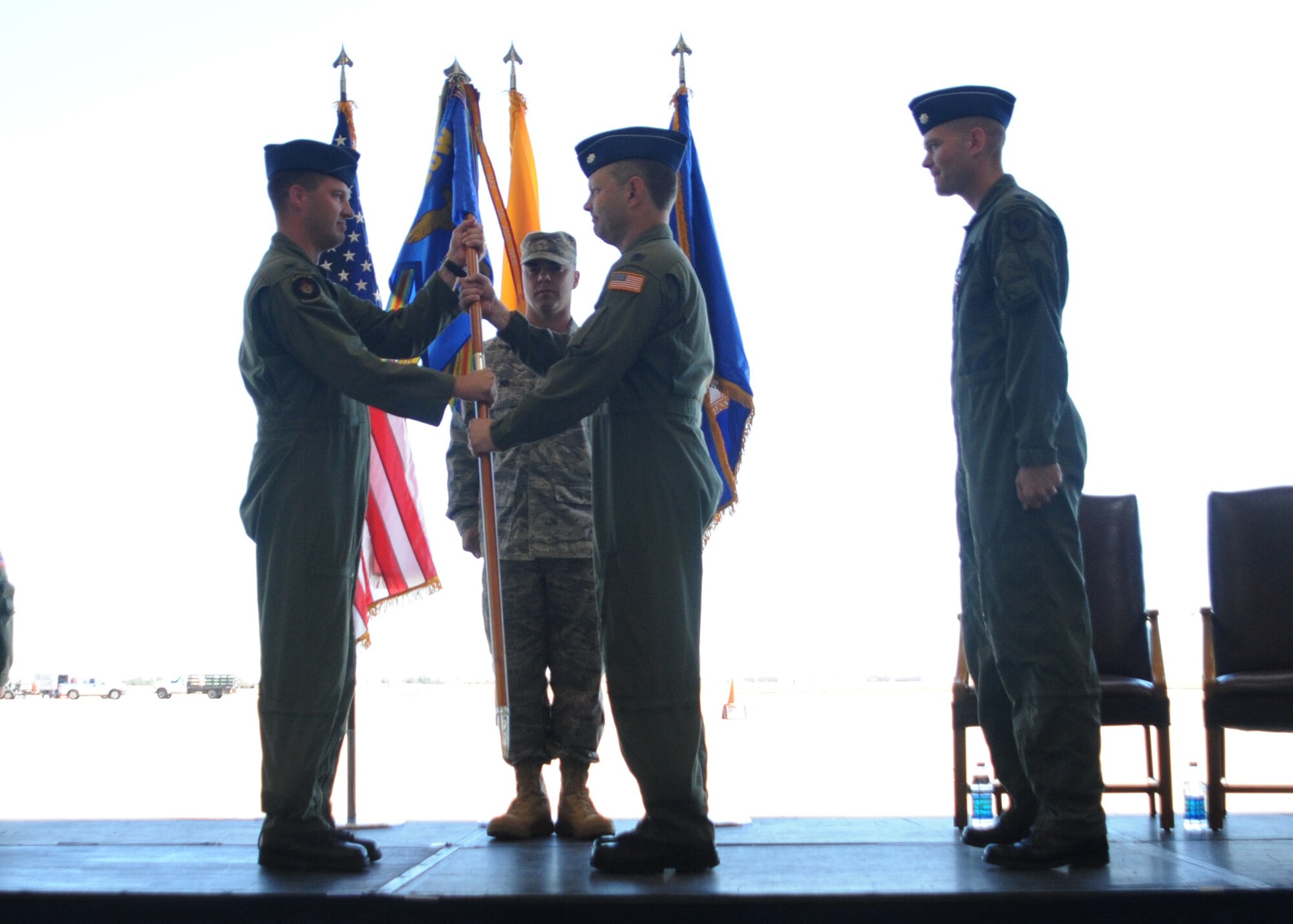 CANNON AIR FORCE BASE N.M.-- Col. James Cardoso, 27th Special Operations Group commander, transfers the 3rd Special Operations Squadron guidon to Col. Robert Brock, the incoming 3rd Special Operations Squadron commander, Oct. 8.  (U.S. Air Force photo by Airman Maynelinne De La Cruz) 