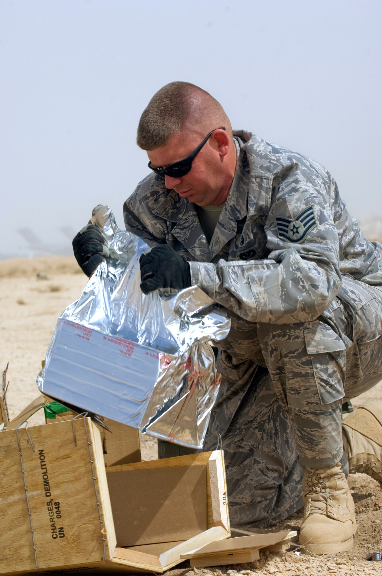Staff Sgt. Kevin Krantz pulls out M-112 demolition charges to destroy expired munitions in a controlled detonation at Joint Base Balad, Iraq, Oct. 2. Krantz, a biomedical equipment craftsman with the 332nd Expeditionary Medical Support Squadron, was an observer during the operation. He is deployed from the 59th Medical Group at Lackland Air Force Base, Texas, and his hometown is Clemons, Mich. (U.S. Air Force photo/Tech. Sgt. Erik Gudmundson)