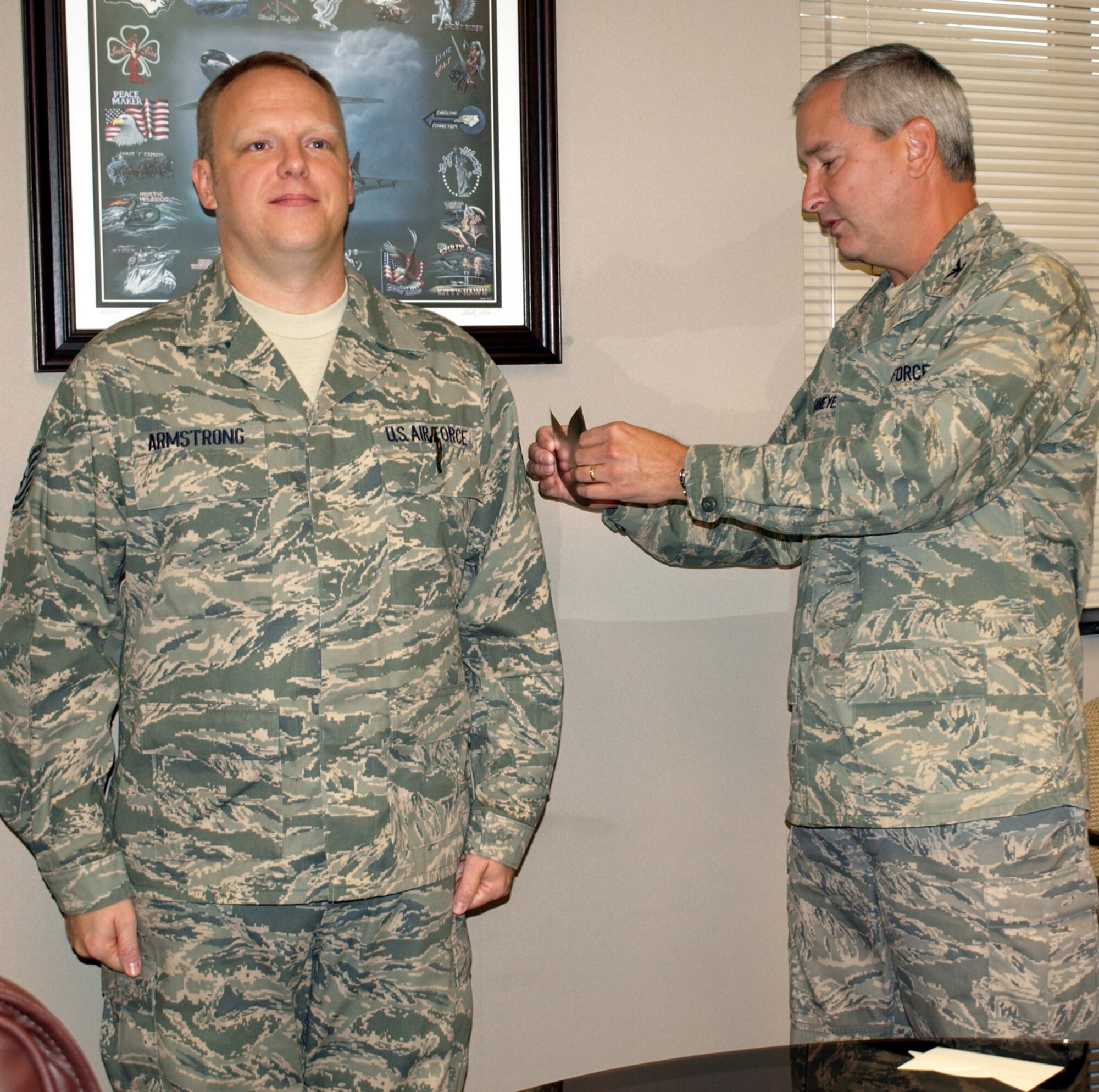 SEYMOUR JOHNSON AIR FORCE BASE, N.C. -- Tech. Sgt. Charles Armstrong (left) receives his new stripes from 916th Air Refueling Wing Commander Fritz Linsenmeyer during the October unit training assembly. Sgt. Armstrong is the knowledge operations manager for wing staff.