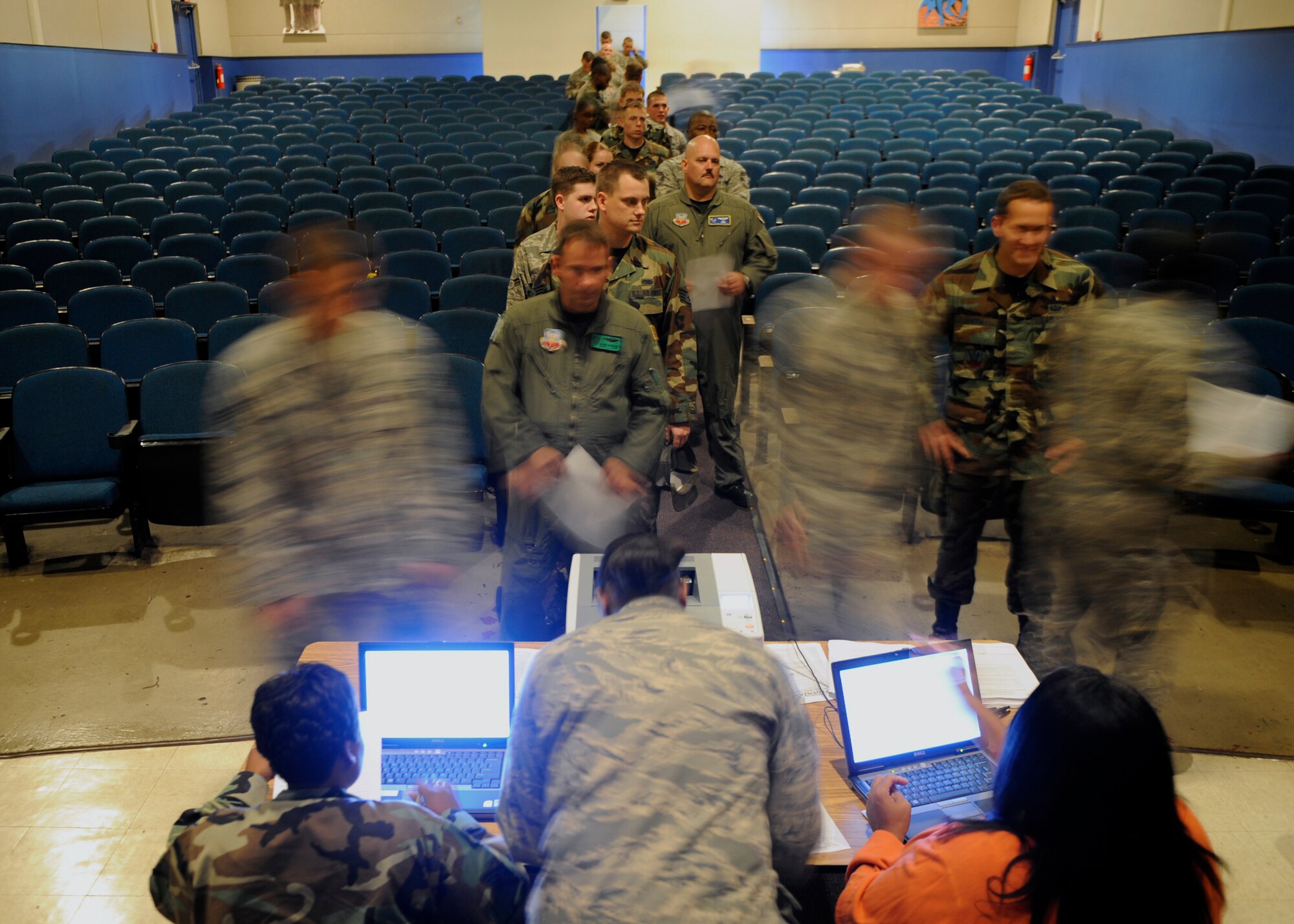 MOODY AIR FORCE BASE, Ga. -- Airmen of the 23rd Wing wait in line to receive intranasal flu mist here Oct. 7. The 23rd Medical Group administered the flu mist to active duty personnel in the base theater for two days before the start of "flu season." (U.S. Air Force photo by Senior Airman Brittany Barker)
