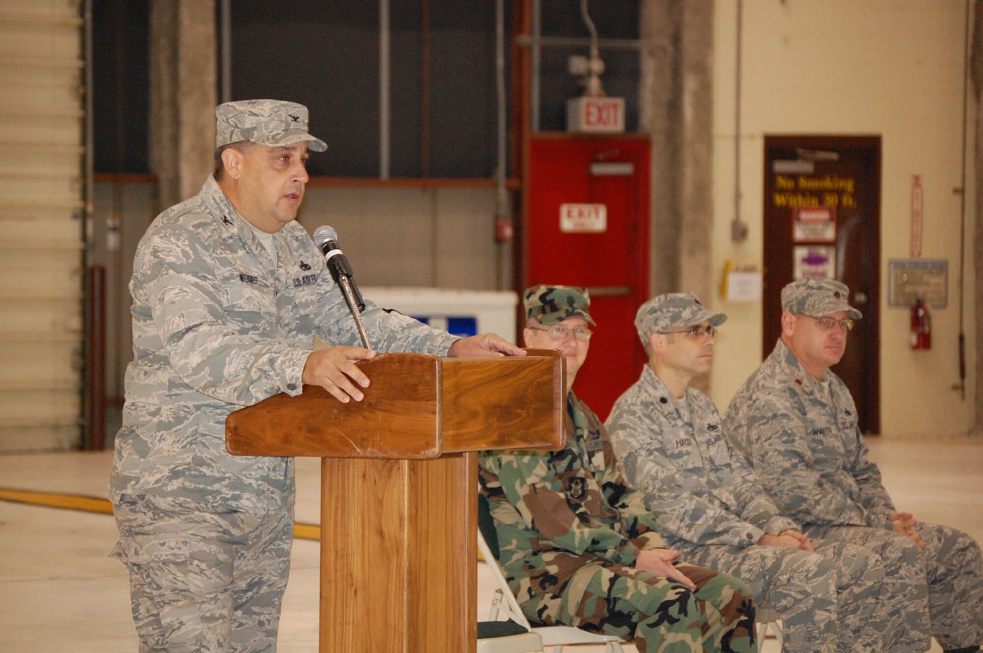 SEYMOUR JOHNSON AIR FORCE BASE, N.C. -- Col. Paul Weimer (standing), commander of the 916th Maintenance Group, presides over a historical triple assumption of command for his group during the October unit training assembly. Seated is Lt. Col. Anthony Hensley, new commander of the 916th Aircraft Maintenance Squadron, Lt. Col. Gregory Halen, new commander of the 916th Maintenance Squadron and Maj. Thomas Walter, new commander of the 916th Maintenance Operations Flight.
